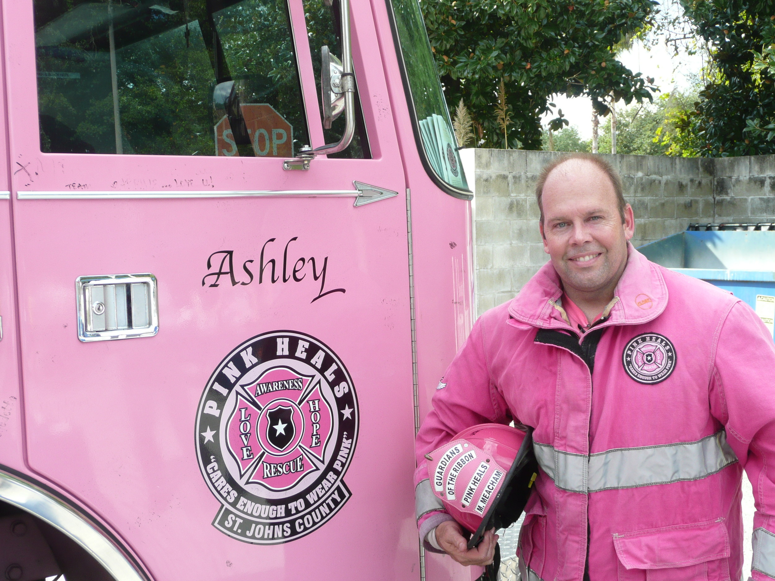 Lt. Mike Meacham  with Pink Heals St. Johns County Chapter and Ashley the fire truck