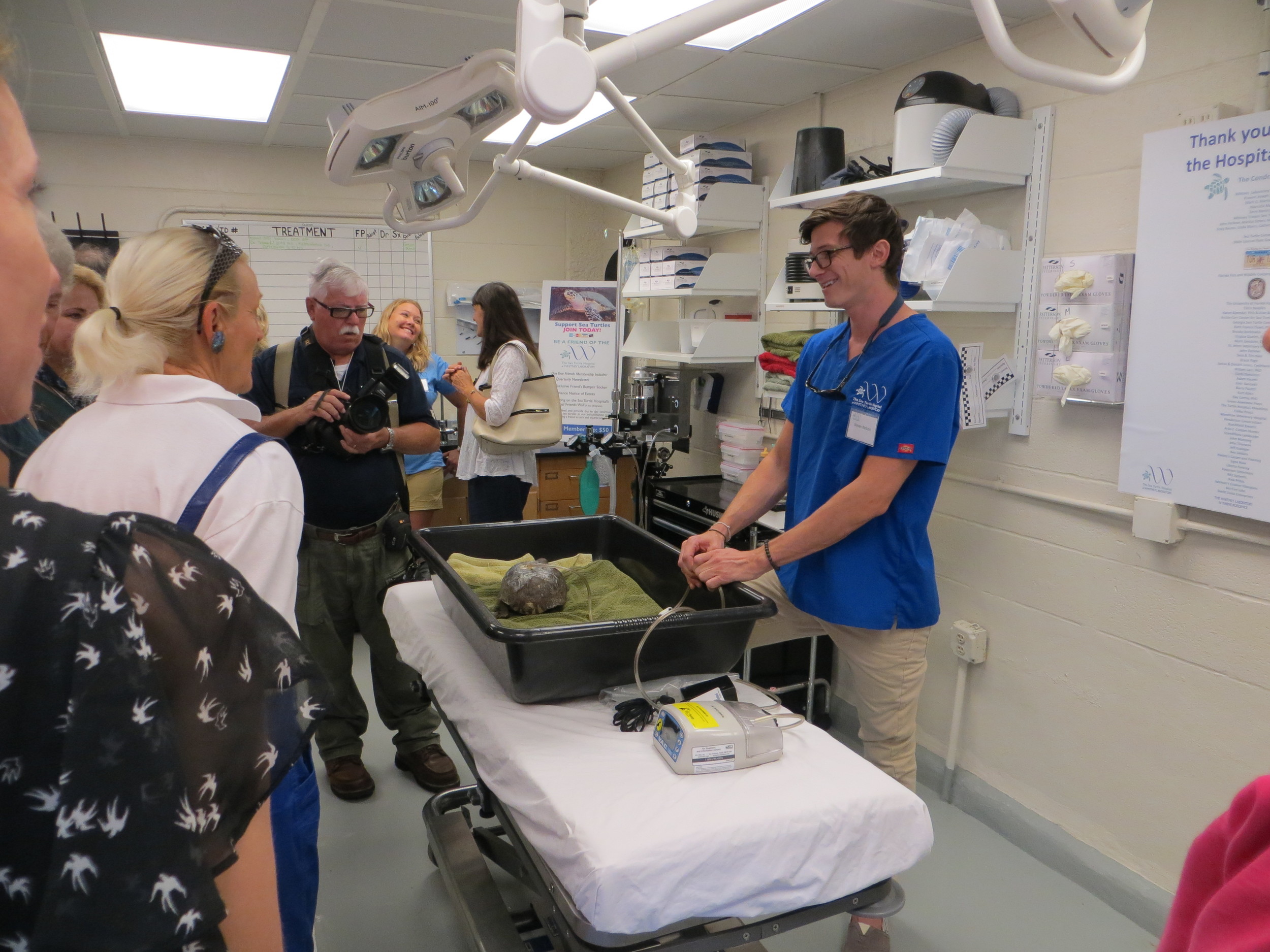 The treatment room: Steven Nelson, certified veterinary technician at the sea turtle hospital, answers visitors’ questions during the grand opening celebration.