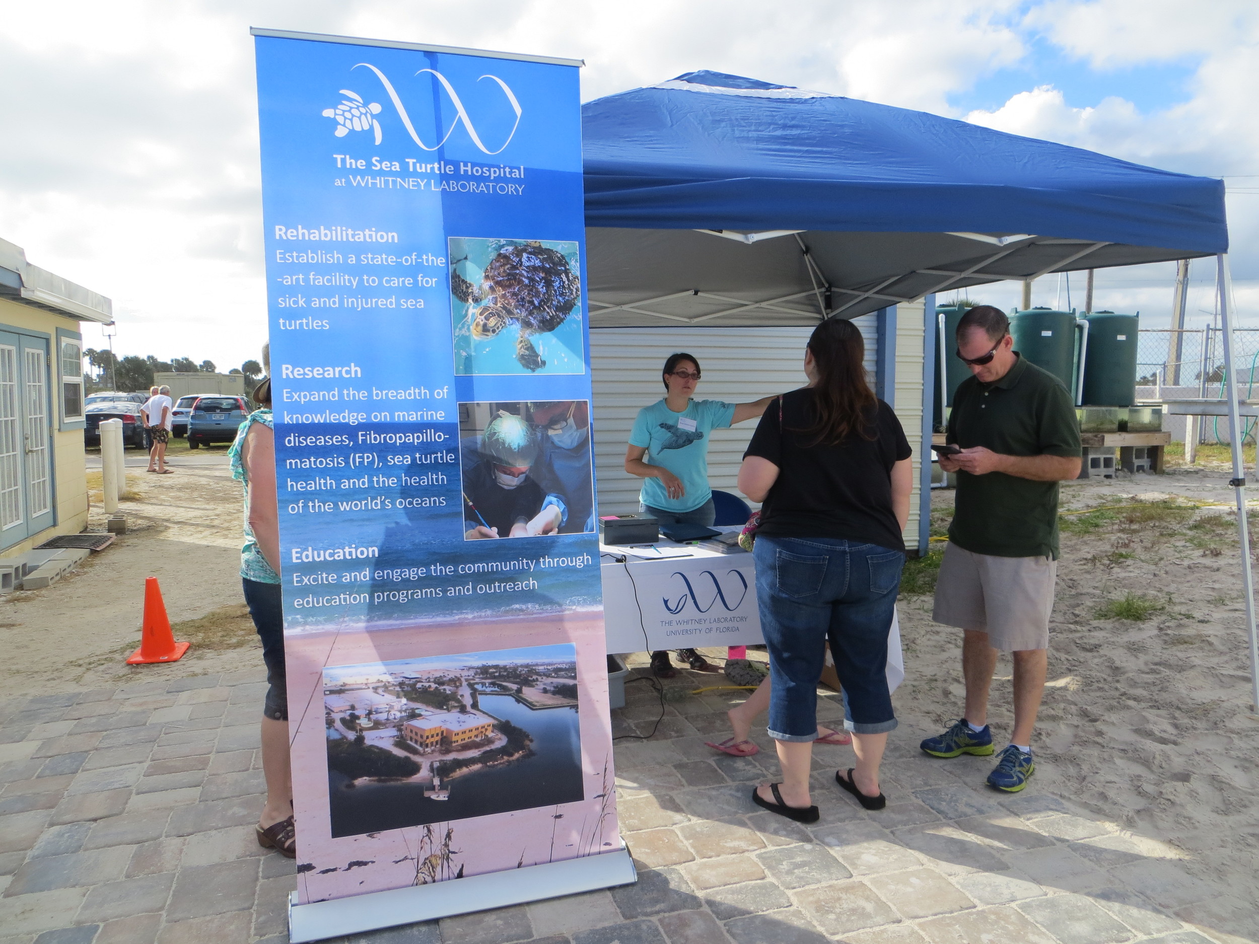 Jesse Grosso Garcia, research grants coordinator for The Whitney Laboratory, greets visitors at the check-in table. The sea turtle hospital was funded through private donors and a State License Plate Grant from the Sea Turtle Conservancy.