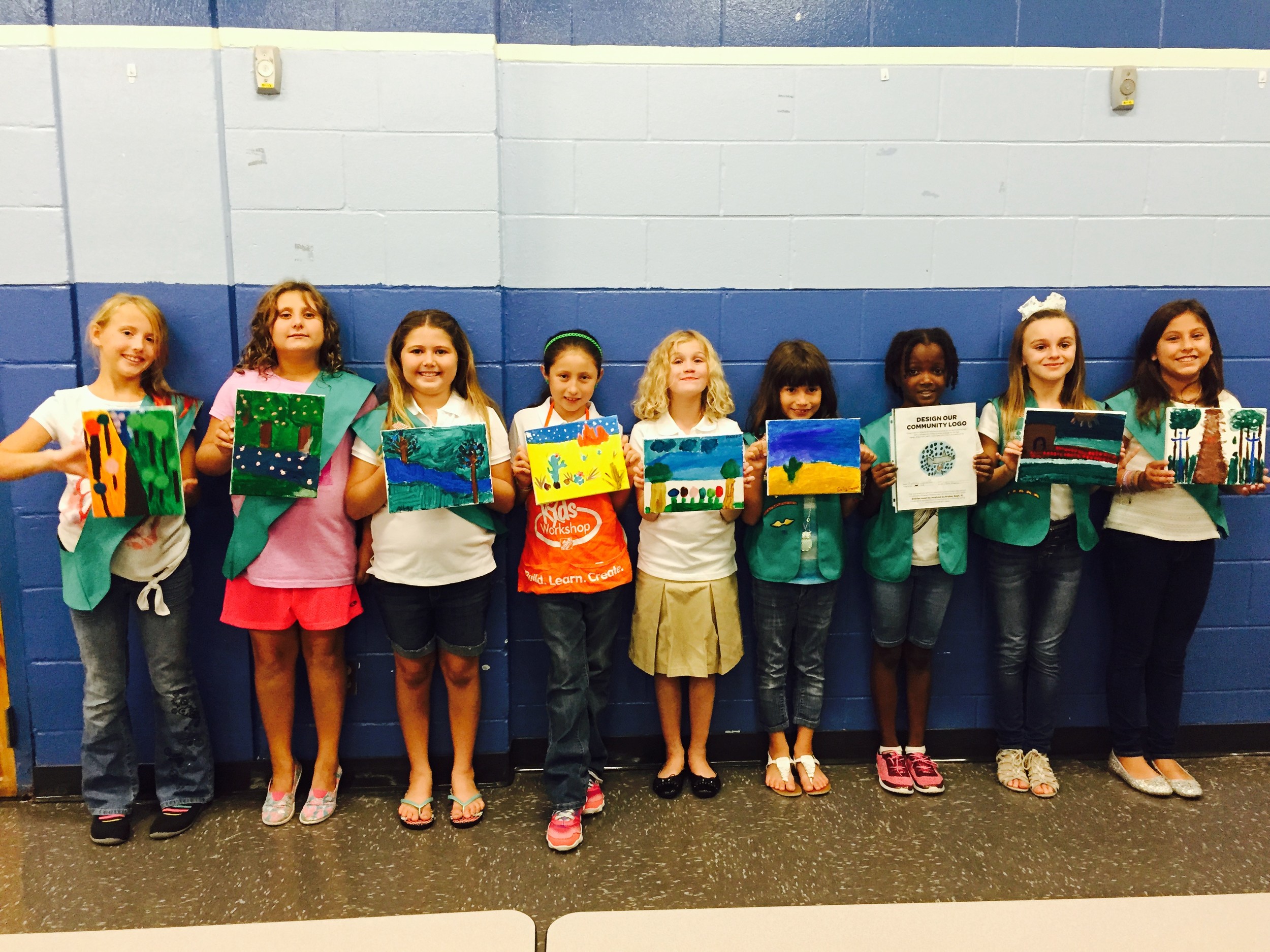 Junior Troop 138 earned their Drawing badge by learning how to use acrylics on canvas, as well as chalk, pastels and water painting. The girls did an art gallery exposition at Mill Creek Elementary school. From left to right: Dakota Moores, Piper White, Abbey Eiseman, Catalina Martinez-Wittinghan, Maddie Badger, Emily Favorite, Audrey Leveille, Olivia Hill & Victoria Lenoir.
