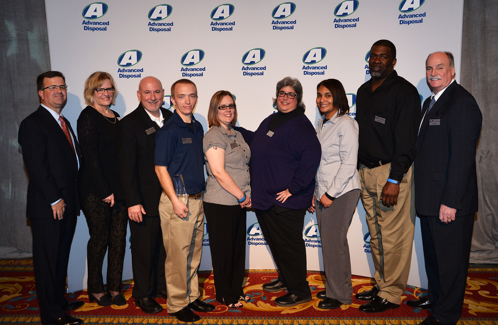 From left: Advanced Disposal’s Richard Burke, CEO; Lori Lamb, Trash Talker of the Year; Steve Edwards, Municipal Marketer of the Year; Harvey Corrigan, Good Samaritan of the Year; Jenny Taylor, Admin./Clerical I Employee of the Year;  Regina Caronia, CEO’s Award;  Alverda Galon, Admin./Clerical II Employee of the Year;  Joseph Fail, Operations Employee of the Year; and John Spegal, COO.