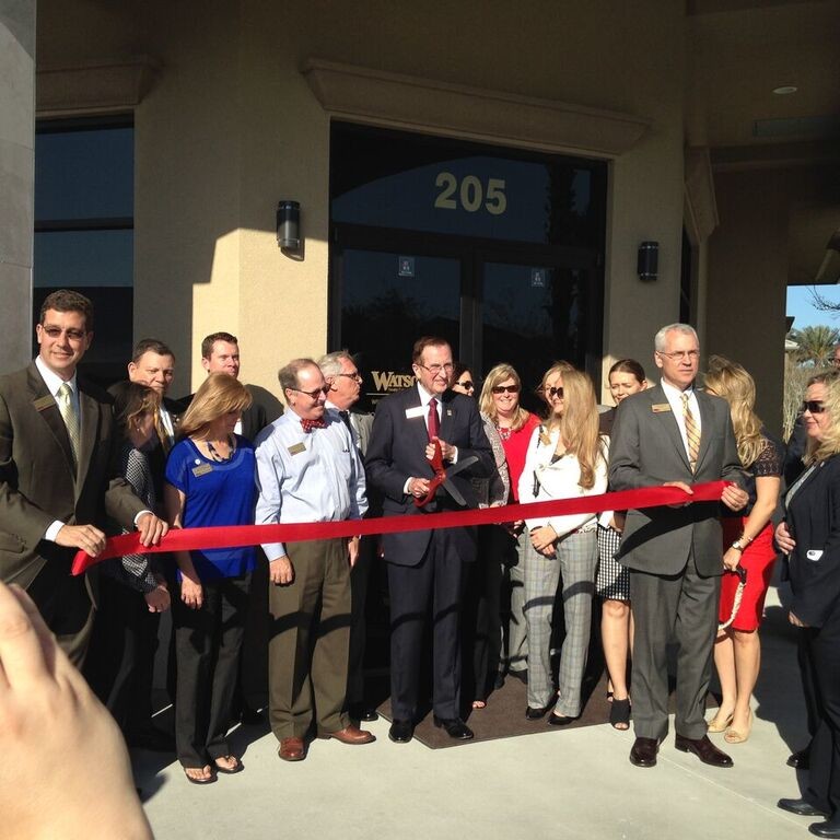 Watson Realty Founder and Chairman William Watson cuts the ribbon on the company's new Nocatee office.
