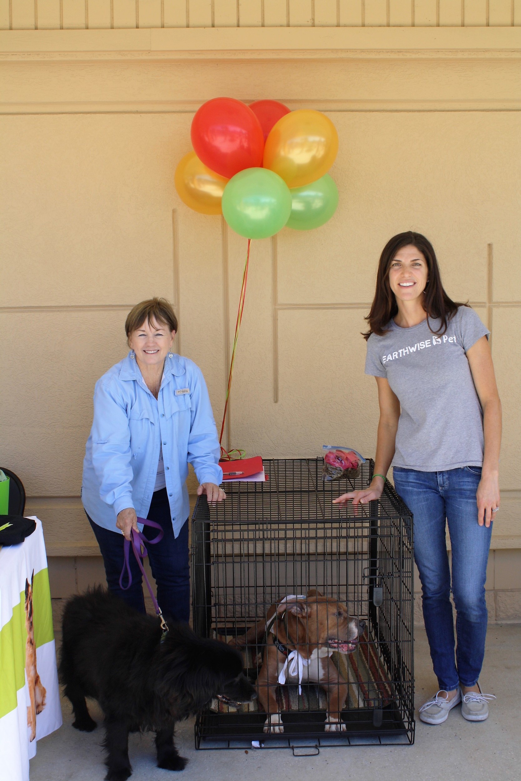 Carolyn Edwards (left) of Friends of Jacksonville Animals joins EarthWise Pet Supply owner Valerie Costello at the Jacksonville Beach store's grand opening celebration. The event featured booths by a number of local animal shelters, which brought along pets available for adoption. The Store also awarded a year's supply of free pet food and other prizes throughout the day.