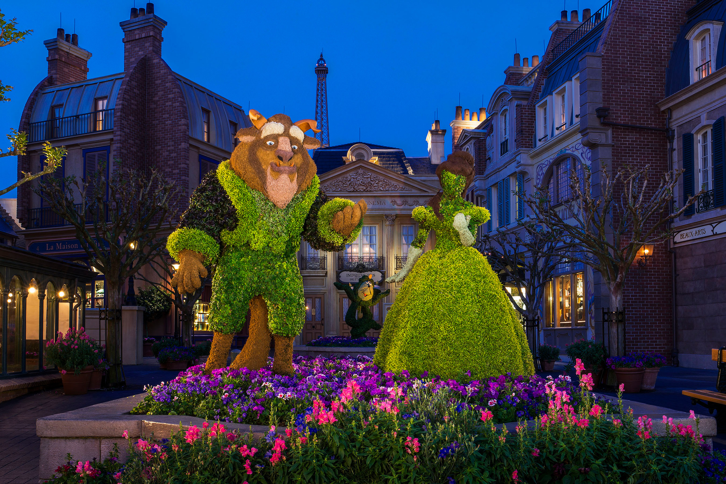 Belle and Beast in topiary form pose by a colorful garden at the France pavilion during the Epcot International Flower & Garden Festival at Walt Disney World Resort in Lake Buena Vista, Fla.  At least 25 different plants, grasses and mosses including palm fiber, ficus and lichen are used to create the character topiaries appearing throughout the park's World Showcase and Future World.   (Matt Stroshane, photographer)