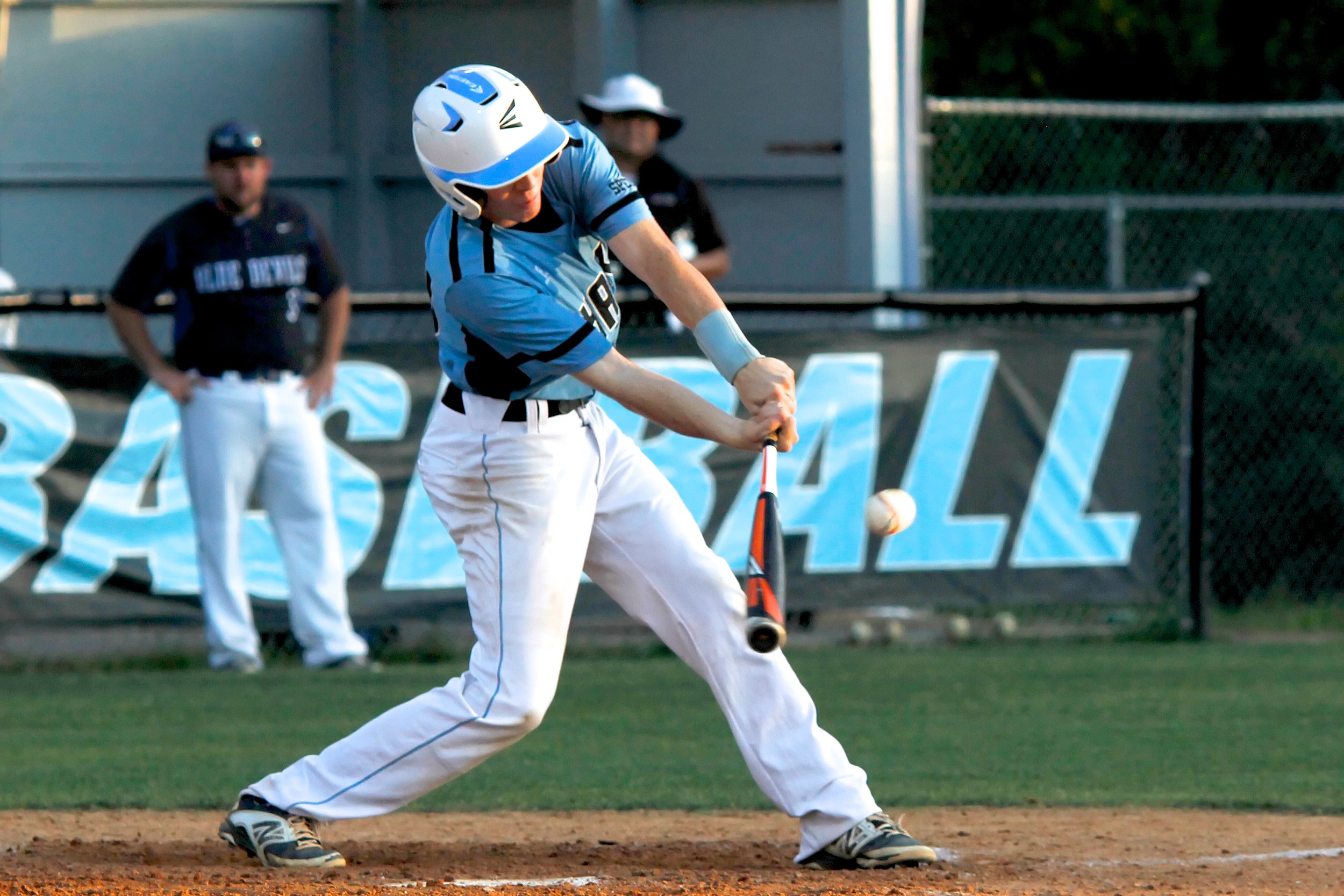 Shark catcher Kevin Mauro slaps a base hit to right for an RBI.