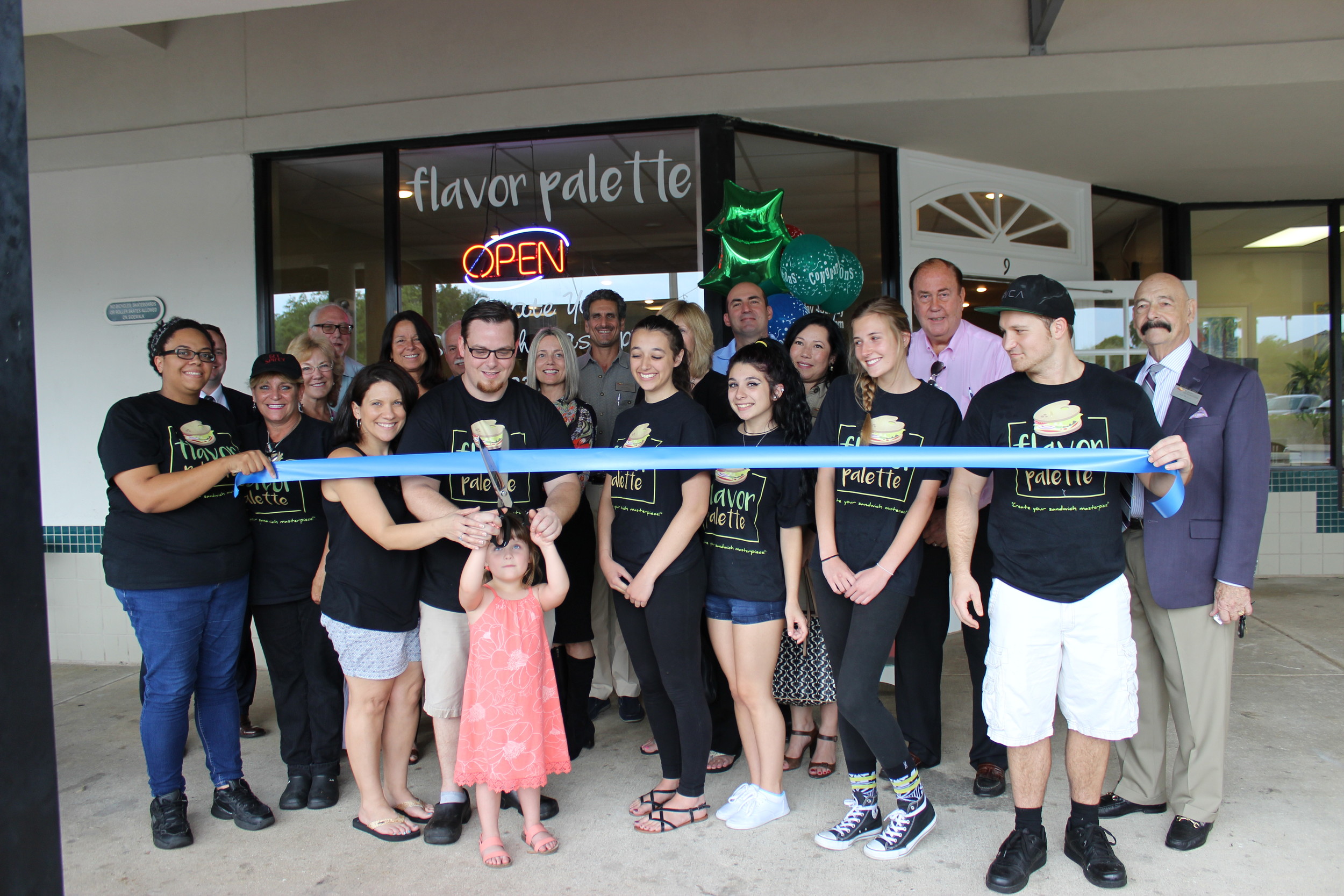 Aided by his family and members of the St. Johns County Chamber of Commerce Ponte Vedra Division, Chef Tommy McDonough cuts the ribbon on his new restaurant, Flavor Palette.