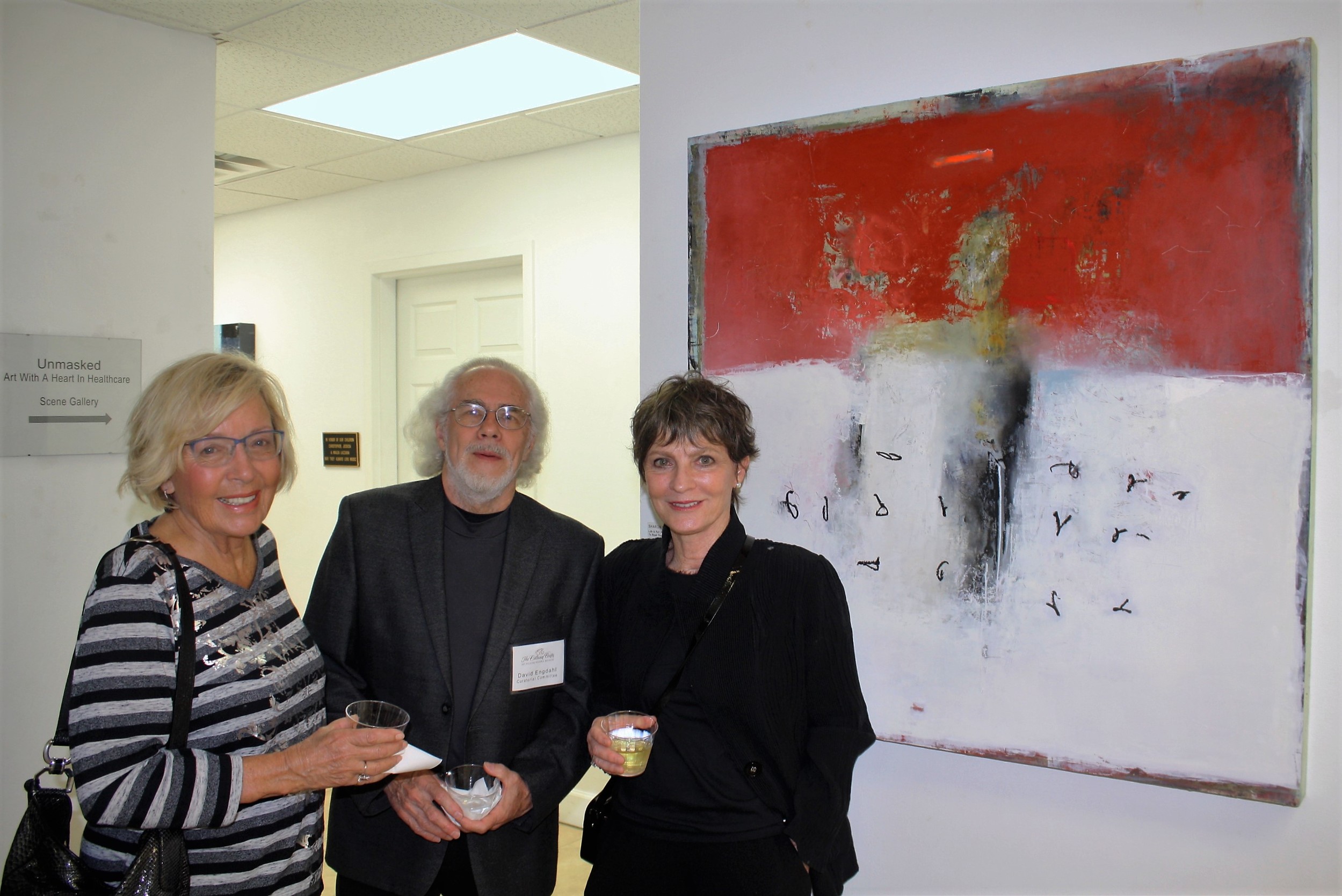 Gabrielle Van Zon, David Engdahl of the cultural center’s curatorial committee and Dita Domonkos with one of Sharon Booma’s works