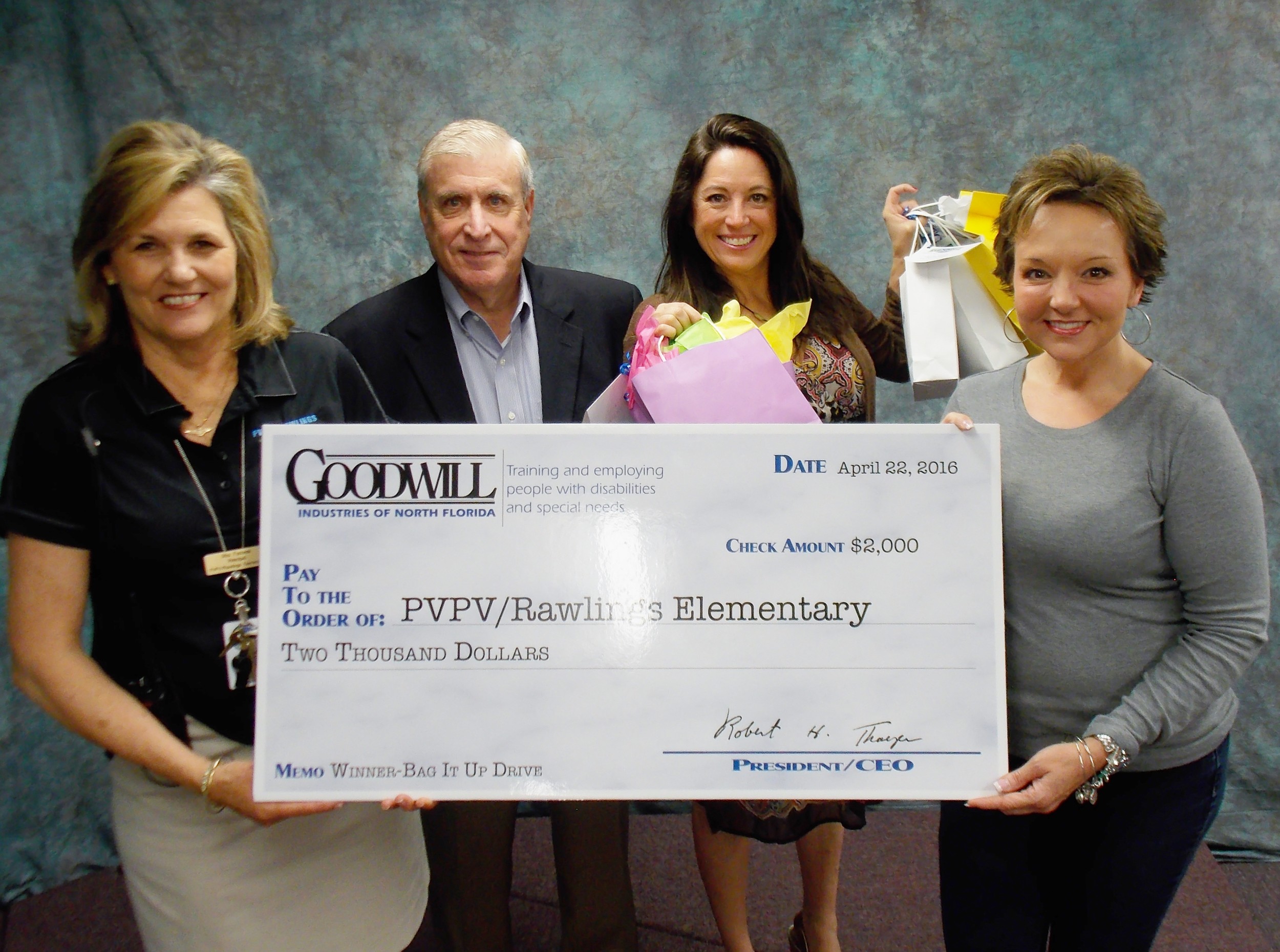 PVPV/Rawlings Principal Kathleen Furness accepts a check for $2,000 from GOODWILL Industries of North Florida CEO Bob Thayer in recognition of the school’s successful “Bag it Up Drive.” From left: Furness, Thayer, GOODWILL Vice President of Marketing Tracy Collins and teacher Dawn Radford