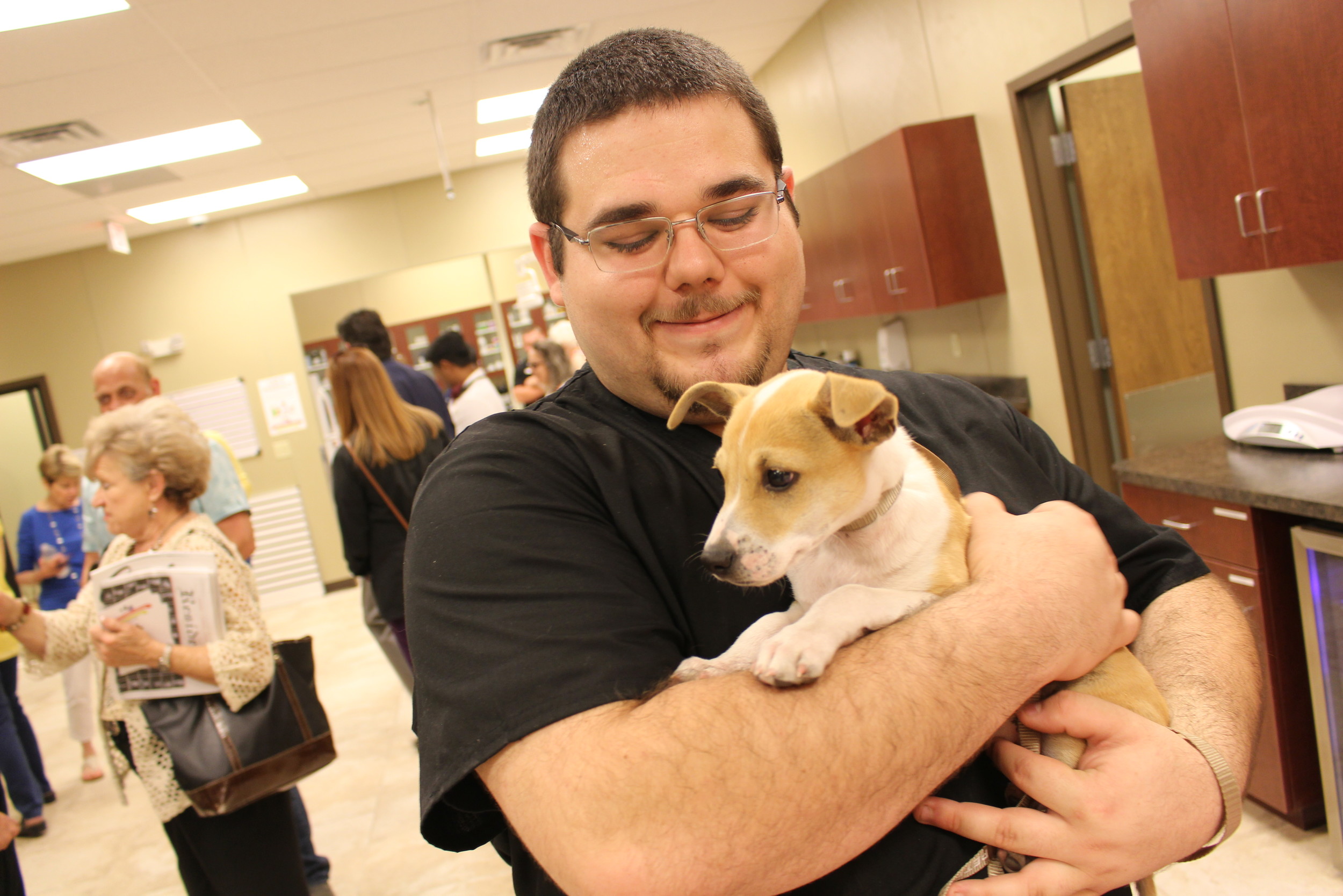 Vet tech with puppy: Veterinary technician Charles Ireland