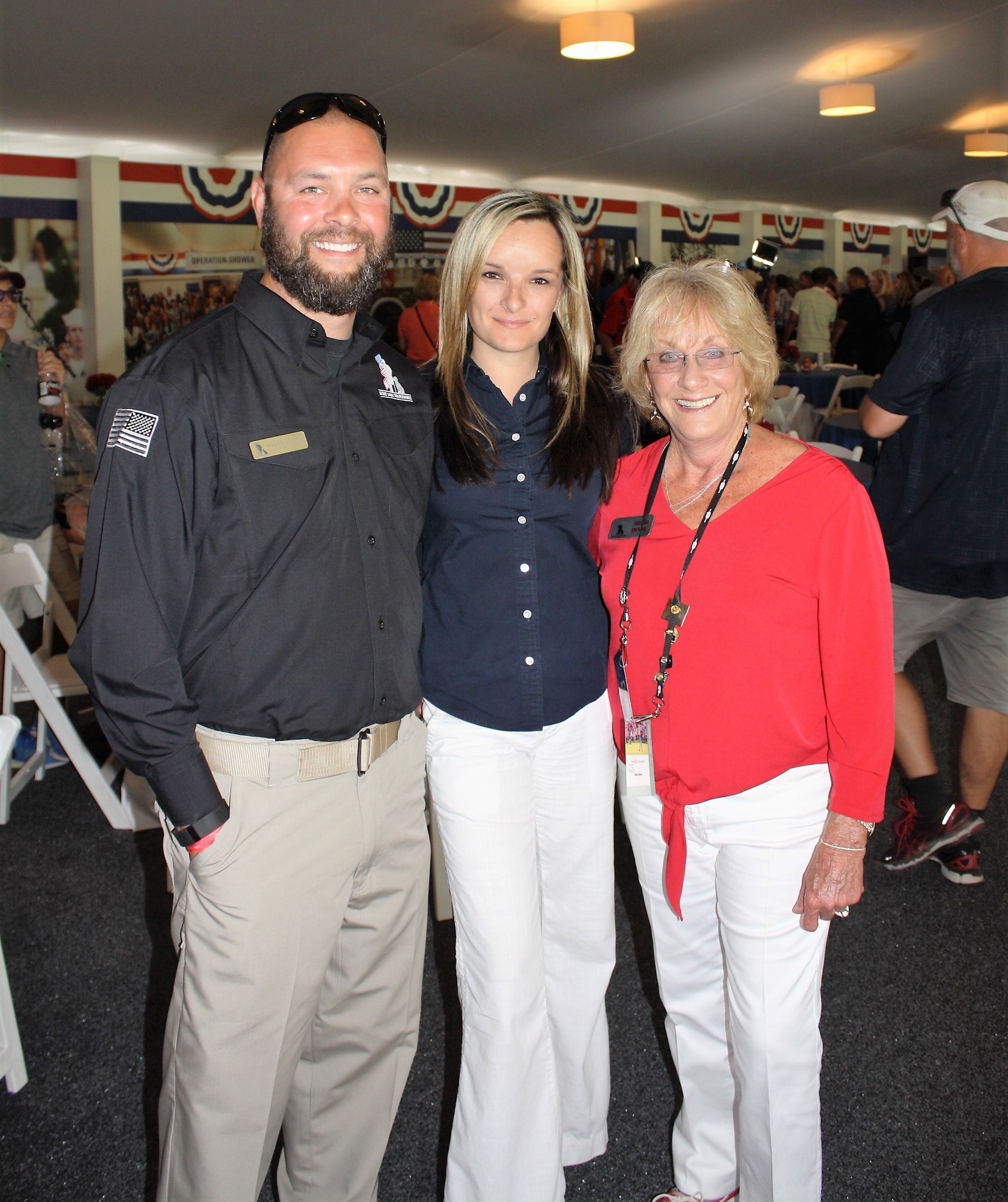 K9s for Warriors Founder Shari Duval (right) joins Director of Warrior Operations Jason Snodgrass and Rachael Maguire. An hour later, Snodgrass proposed to Maguire at the Military Appreciation Day ceremonies.