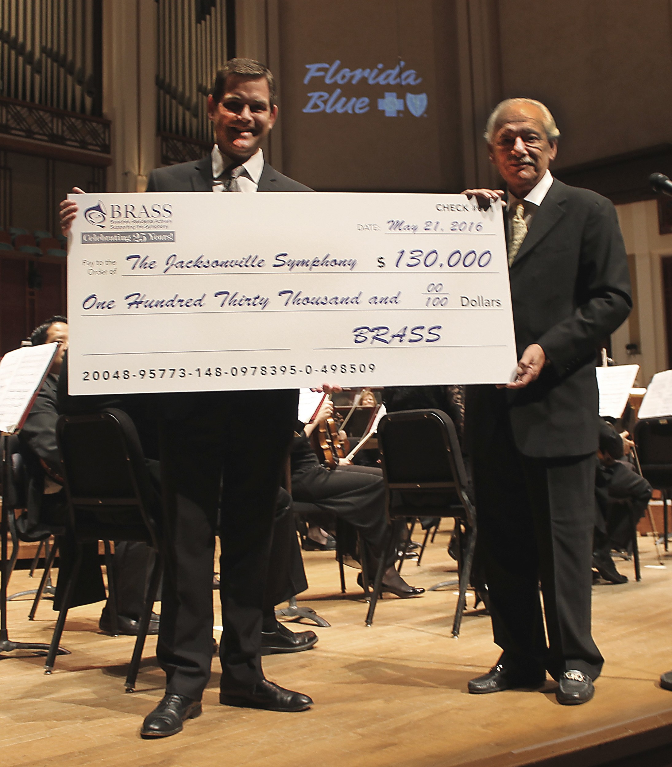 BRASS President Michael Imbriani (right) presents Jacksonville Symphony Association President and CEO Robert Massey with a donation raised through the all-volunteer group’s fundraising efforts.