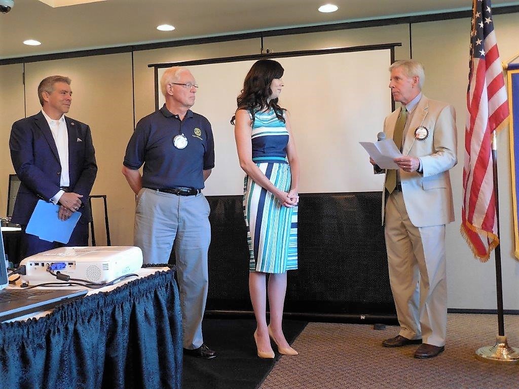 Rotarian Jeptha Barbour (right) inducts Ponte Vedra Recorder Managing Editor Jennifer Logue into the club as President Will Montoya (left) and sponsor Chuck Day look on.