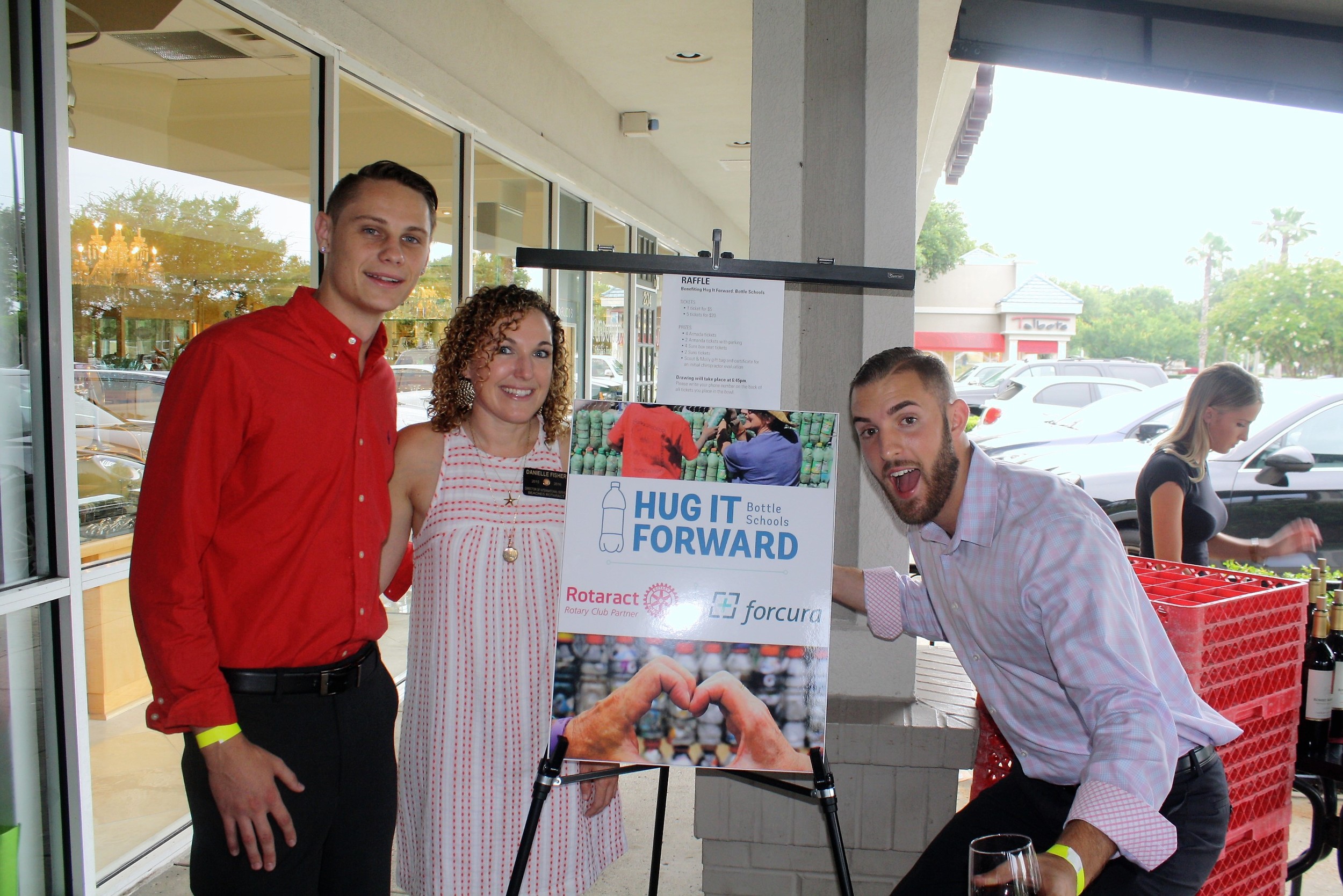 Beaches Rotaract member Danielle Fisher joins Daytona State Rotaract members Justin Gadrim (left) and Michael Tirpak at the wine tasting to raise funds to build a school in Guatemala.