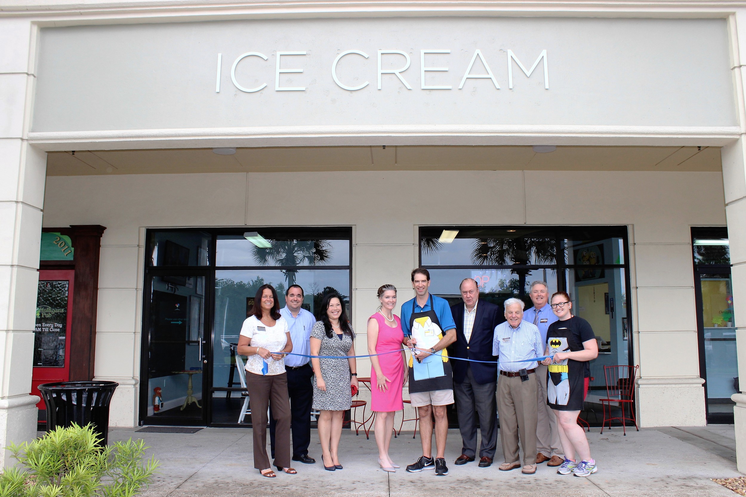 Christy and Jason Leinheiser (center) join with representatives from the Ponte Vedra Beach Division of the St. Johns County Chamber of Commerce to cut the ribbon on their new shop, Christy’s Dream Ice Cream Bar.