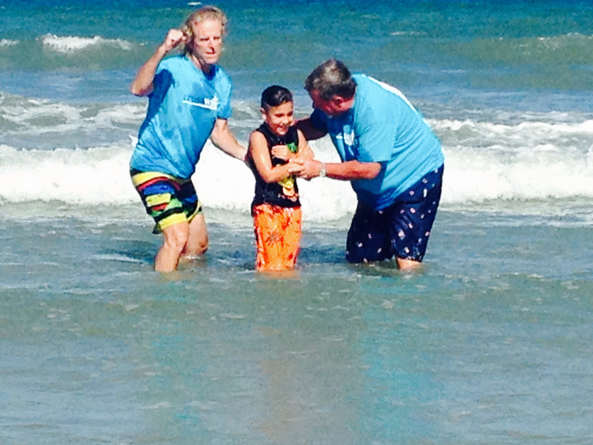 A young boy professes his faith in Jesus through baptism.