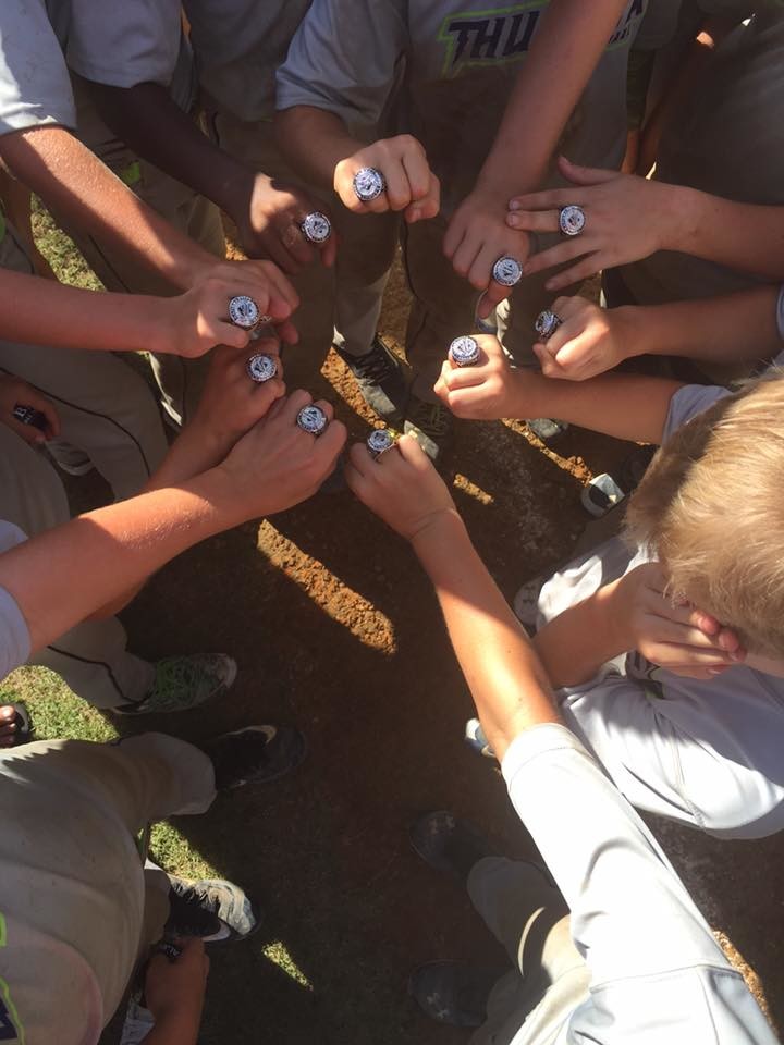 Team members display their championship rings.