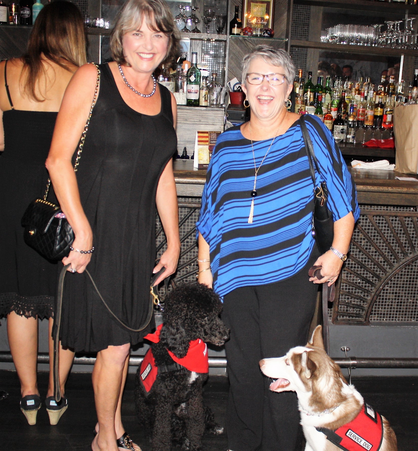 Barbara Jennings and service dog Victory with Mary Daniel and service dog Delaney