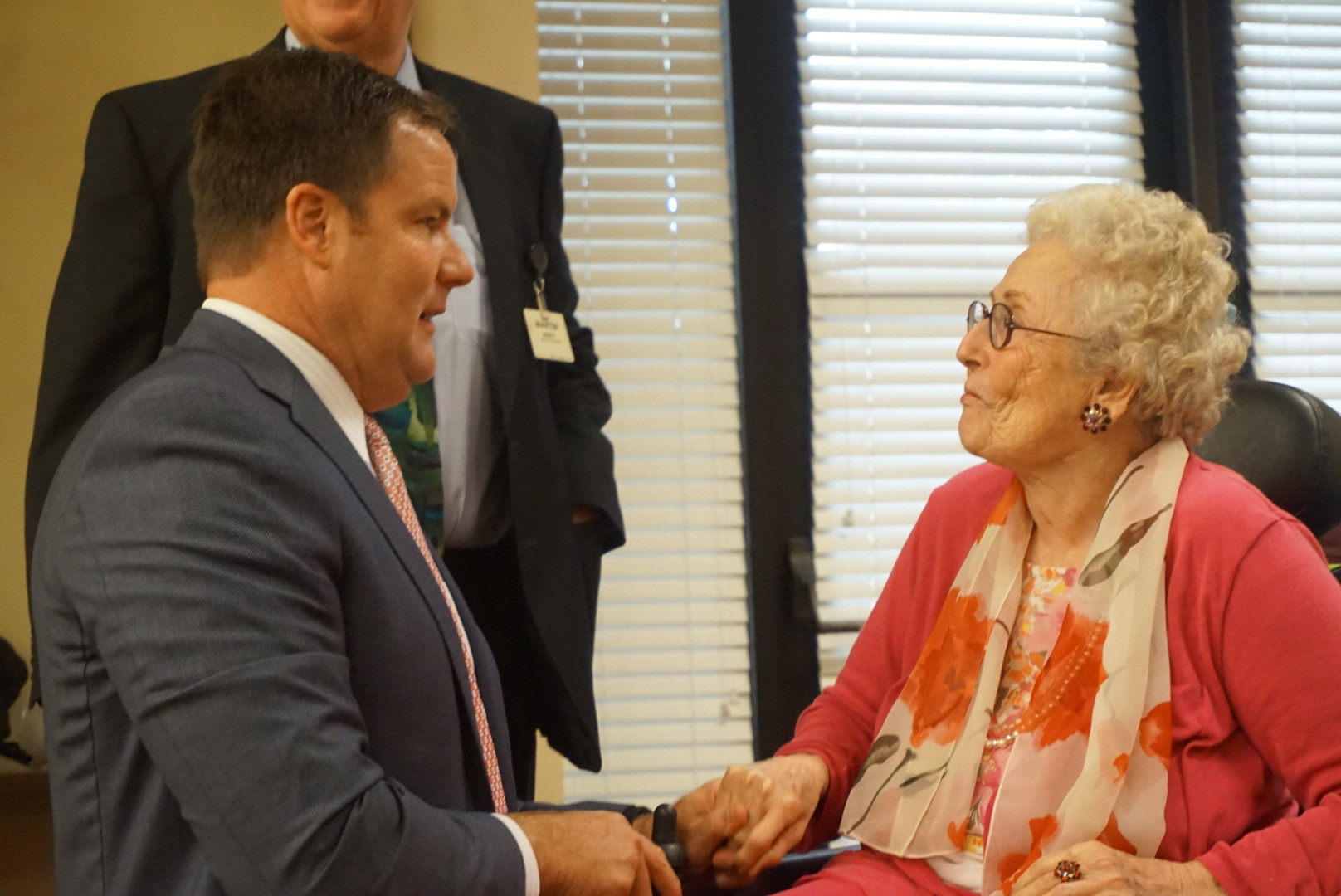 State Sen. Aaron Bean speaks with Shirley Stone, president of the River Garden Council of Residents