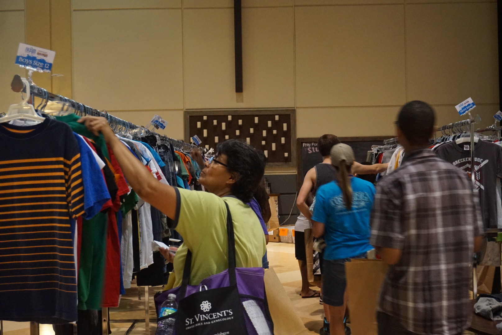 Shoppers peruse racks of clothing