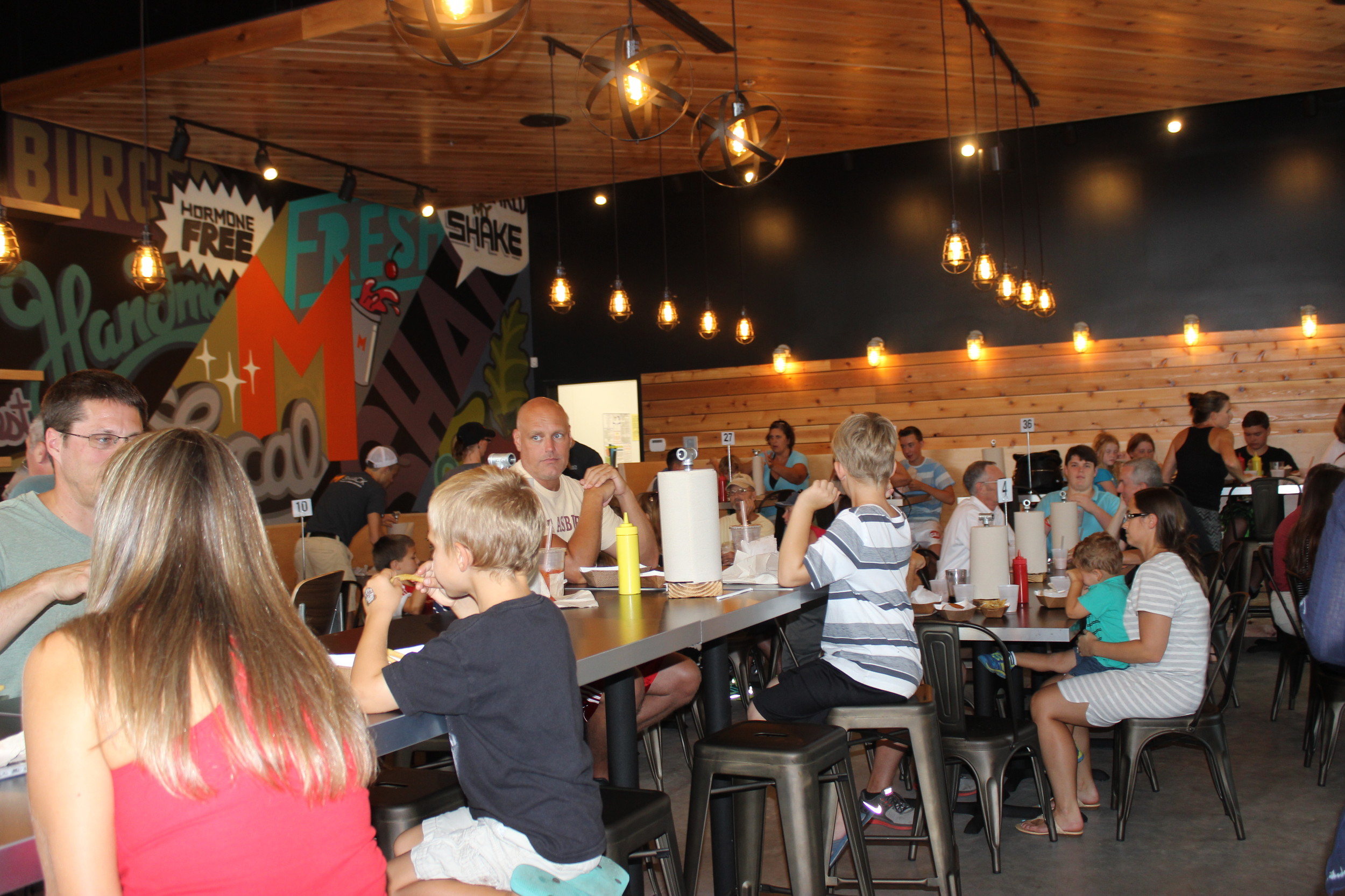 Patrons enjoy a meal at the grand opening of the Nocatee M Shack