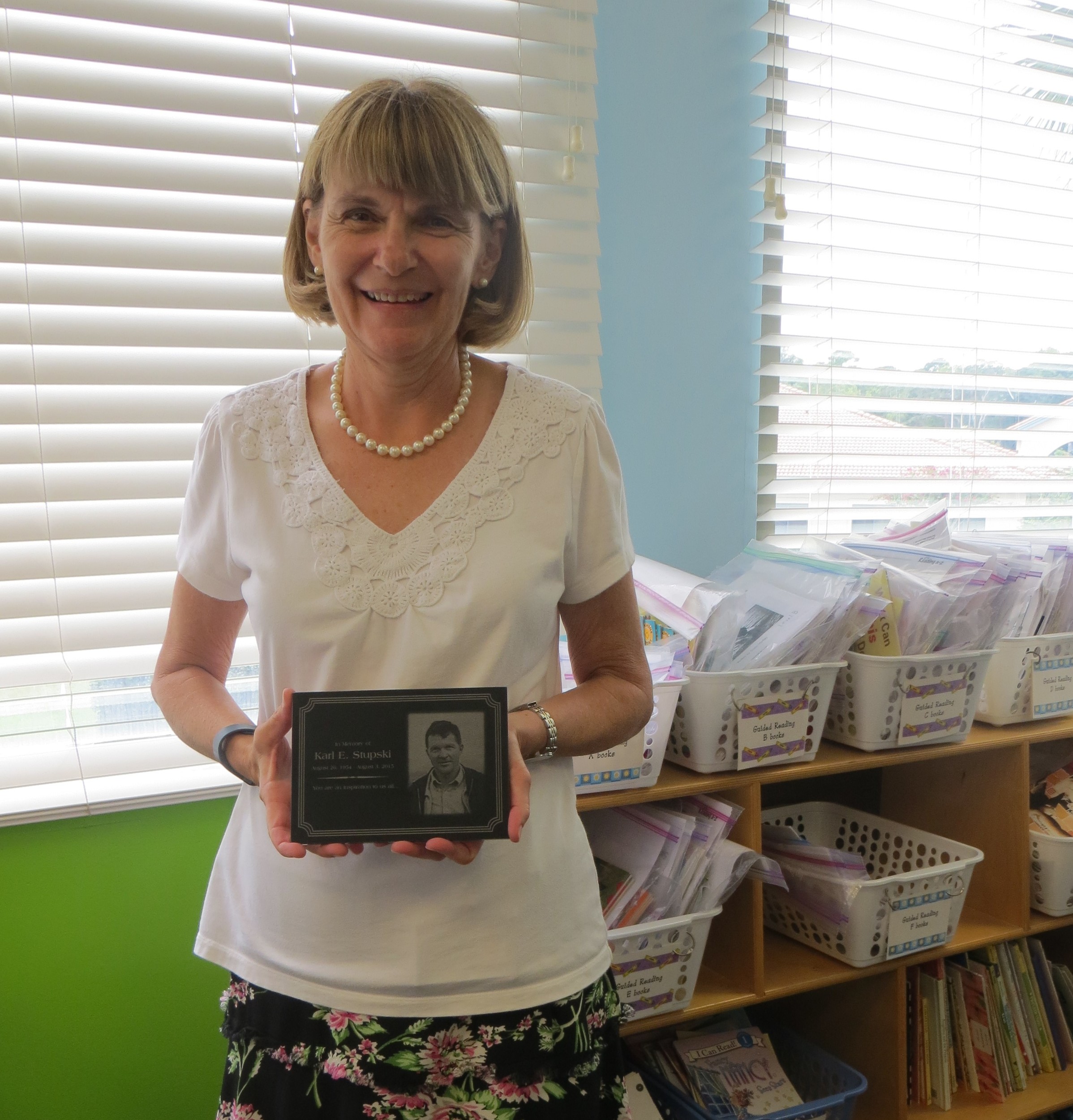 Bolles Lower School Ponte Vedra Kindergarten Teacher Cathy Stupski displays a plaque given to her by her late husband’s employer.