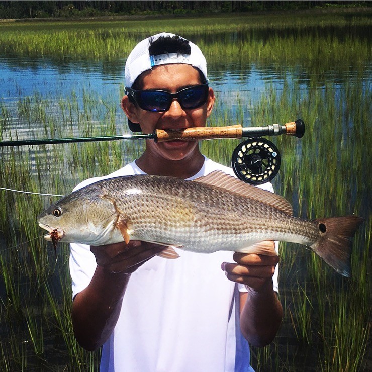Andre’ Mauriello displays one of the fish that won him the Older Teen Fly Division in the RiverLife youth fishing tournament.