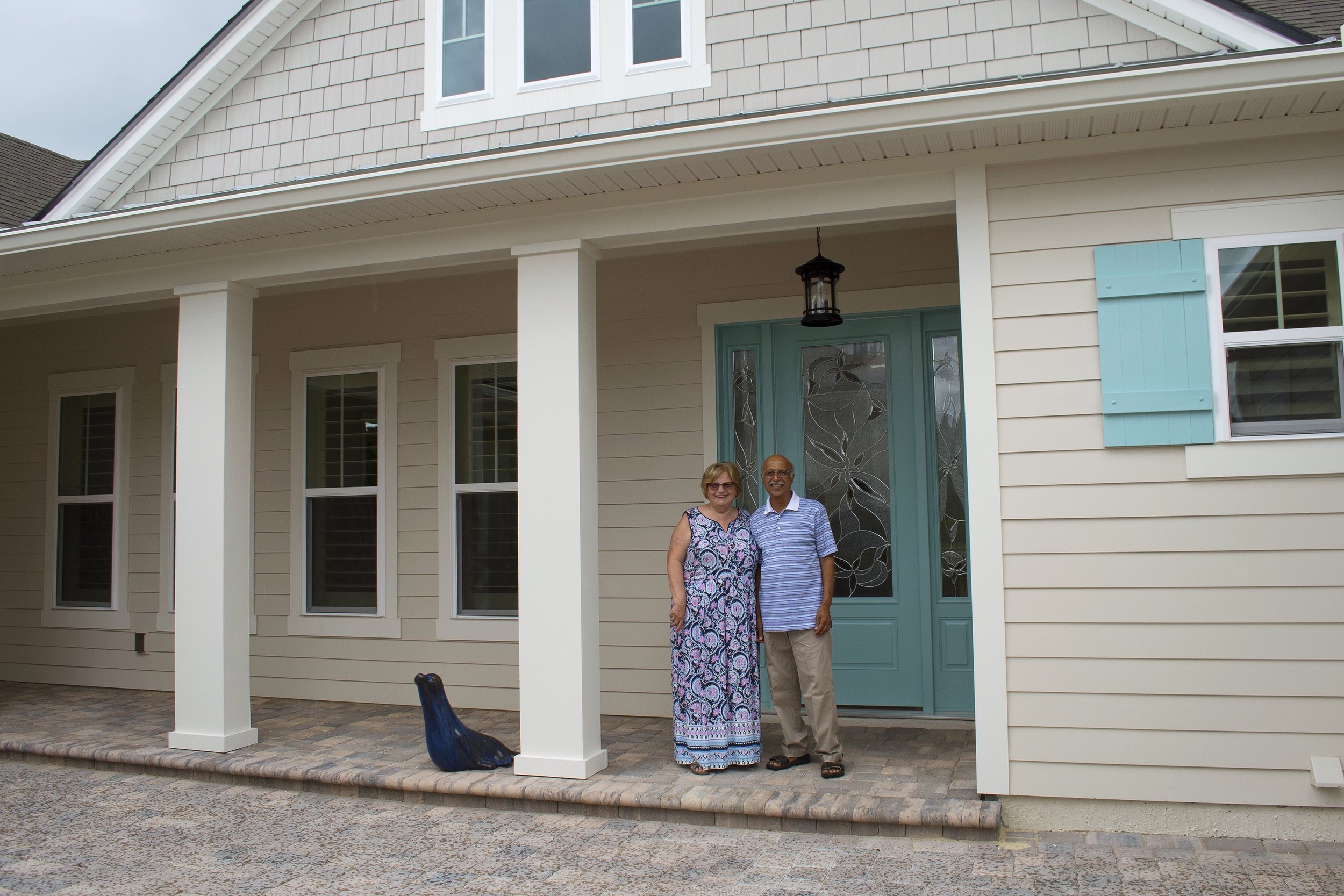 Markland’s first residents, Lynne and Raj Natarajah, stand in front of their lakefront home in Markland, A Hines Community off International Golf Parkway. (August 2016)