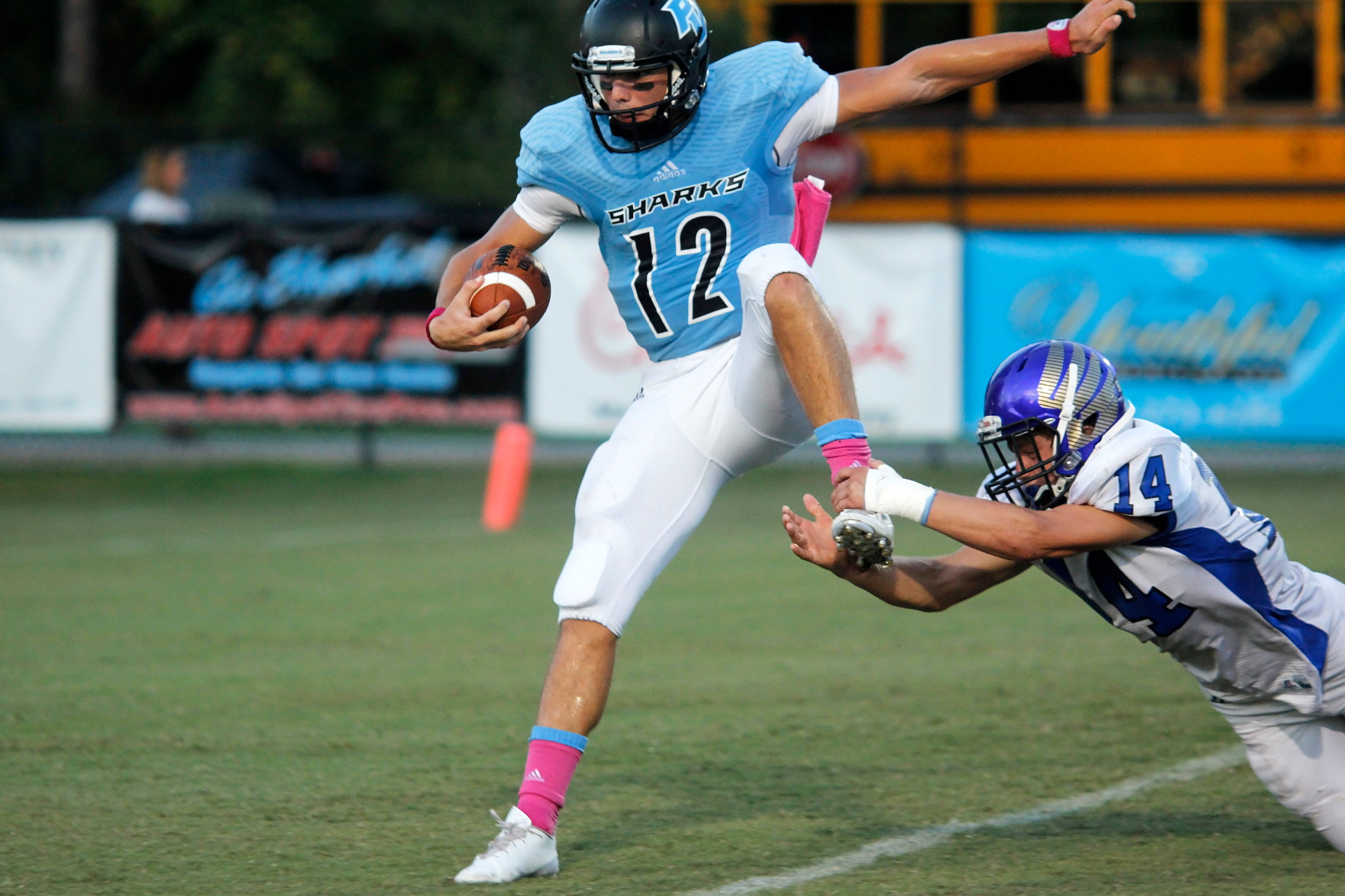 The Sharks’ Nick Tronti runs out of the grasp of a Menendez tackler for a touchdown