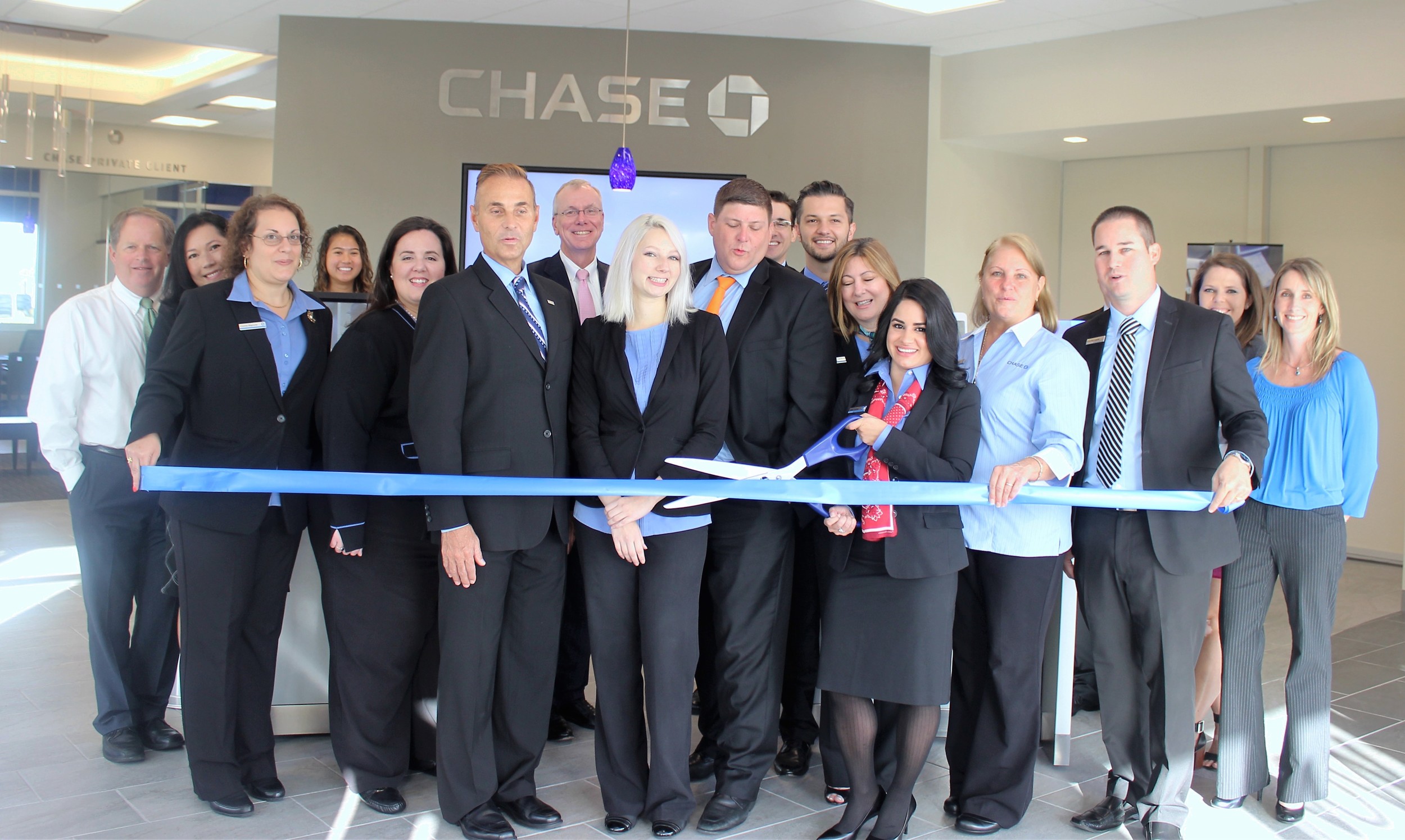 Branch Manager Leidy Cuartas cuts the ribbon at the new Chase Bank branch in Nocatee Town Center. Members of the Ponte Vedra Beach Division of the St. Johns County Chamber of Commerce were on hand to welcome the bank to the local business community.