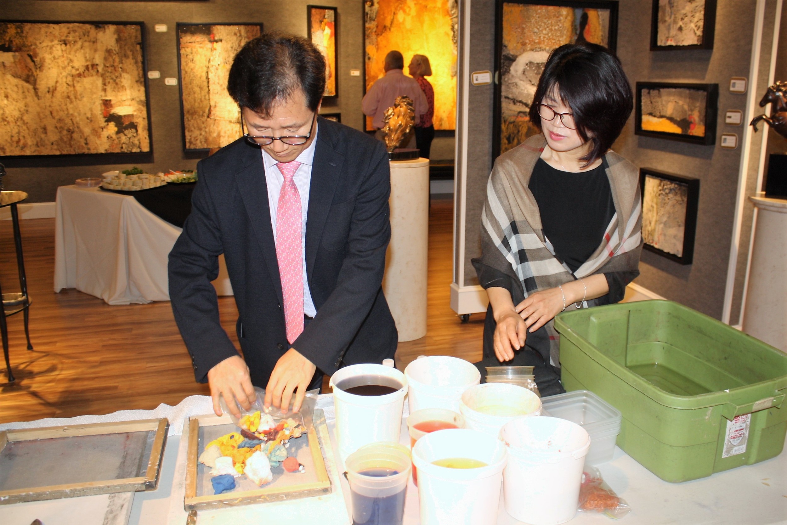 Artists Jeong and Choon Yun display some of their handmade paper tapestries at Cutter & Cutter Fine Art in Sawgrass Village.