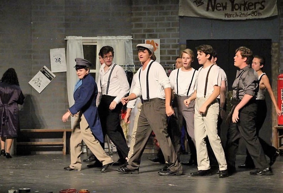 Grant Burmeister (center) joins the cast in one of the production’s musical numbers.