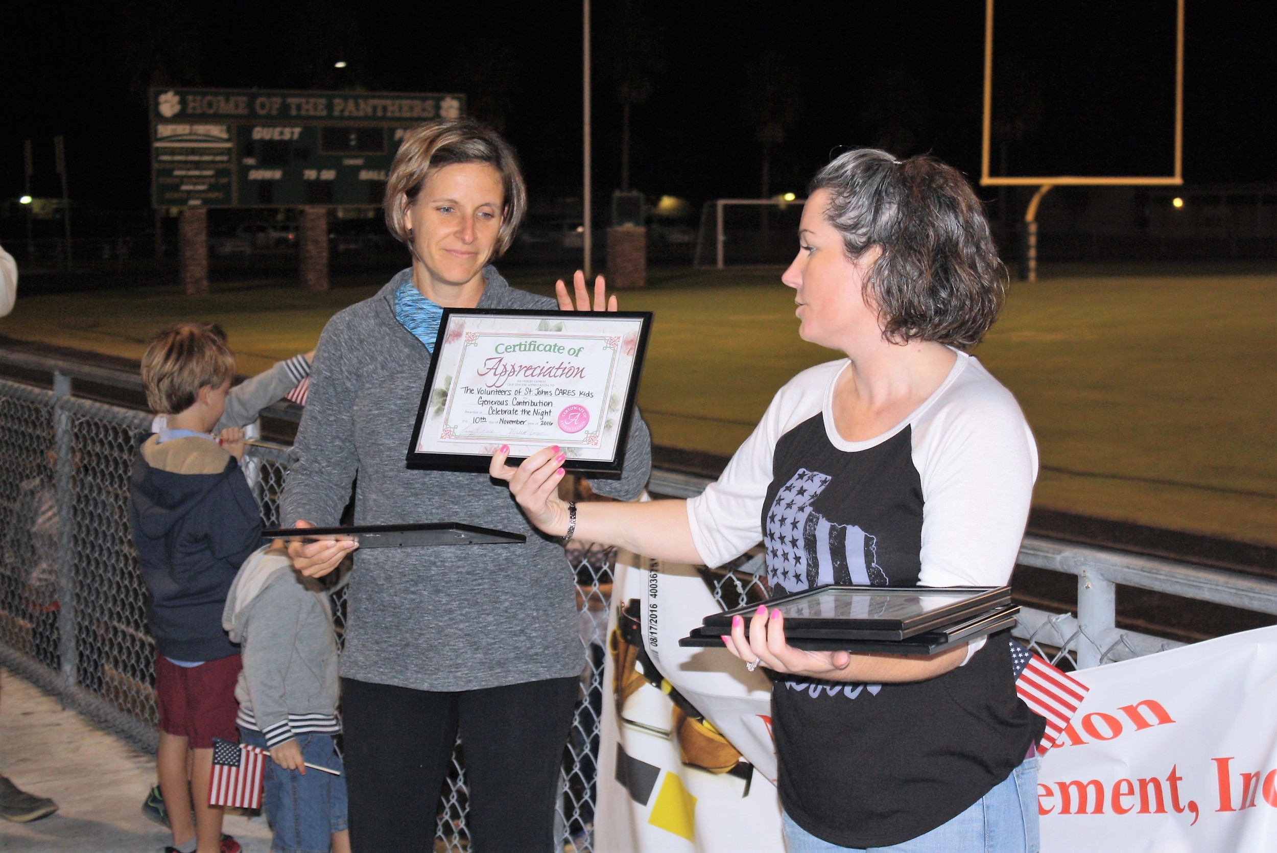 Jill D’Amato of St. Johns Cares Kids, which helped organize the event, receives a certificate of appreciation.
