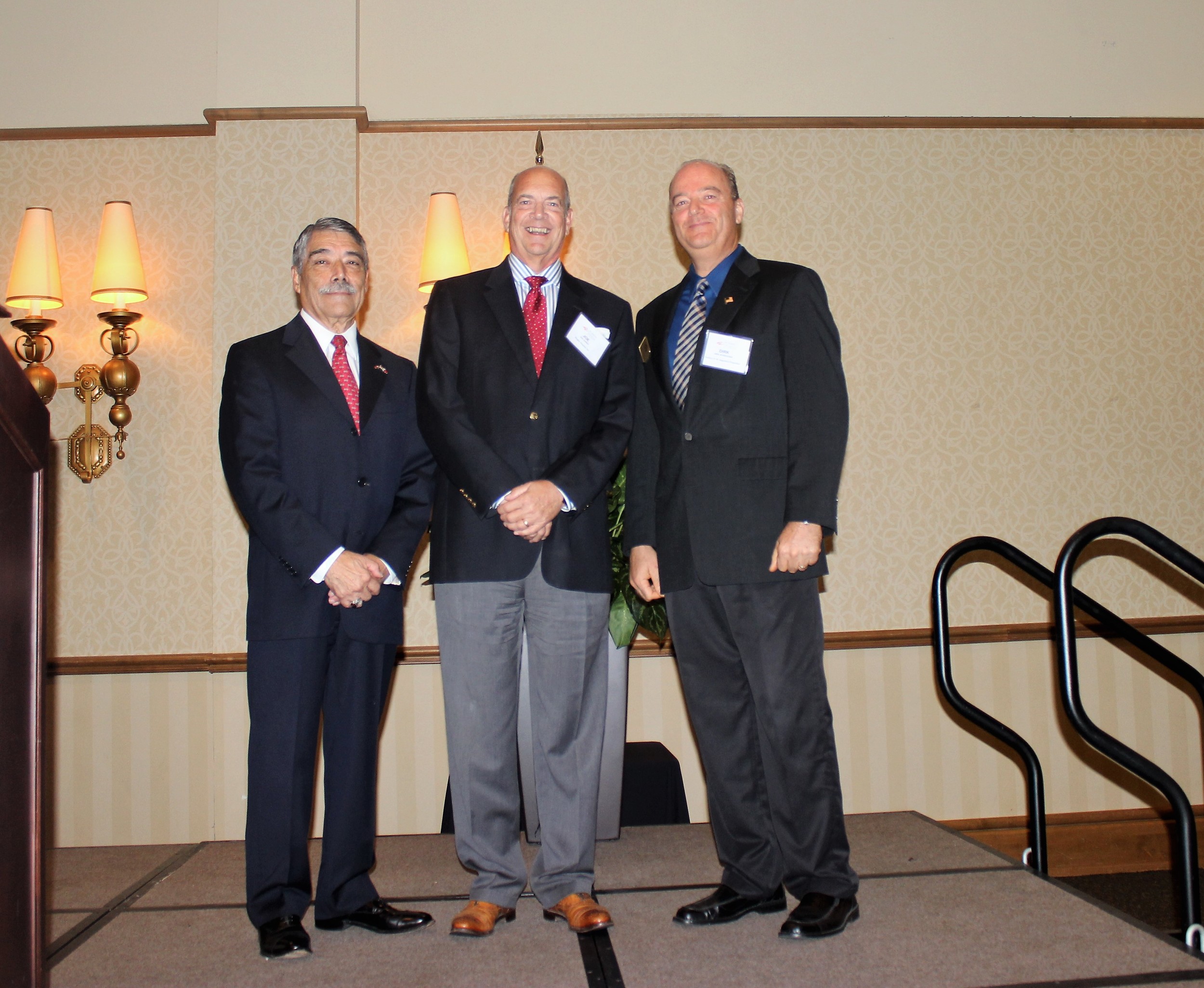 Flagler Hospital President Joe Gordy (center) receives the Fred Schroeder EDC Member of the Year Award from EDC Chair Victor Raymos (left) and Schroeder’s son, Dirk Schroeder.