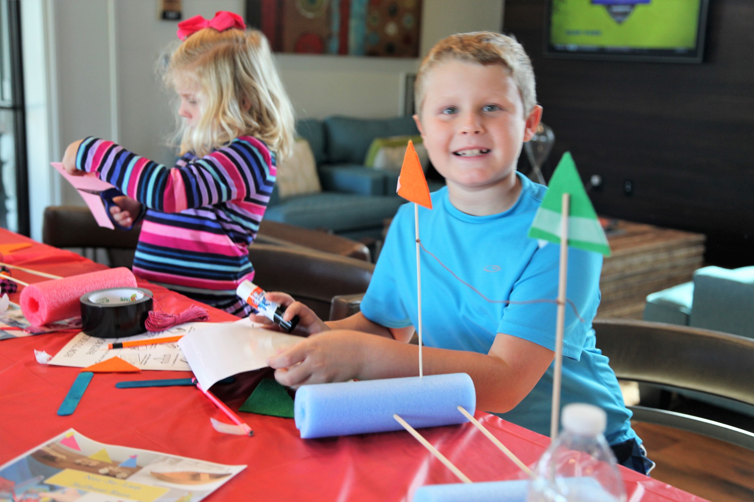 Shearwater kids and parents construct sailboats out of Styrofoam, sticks and other materials.