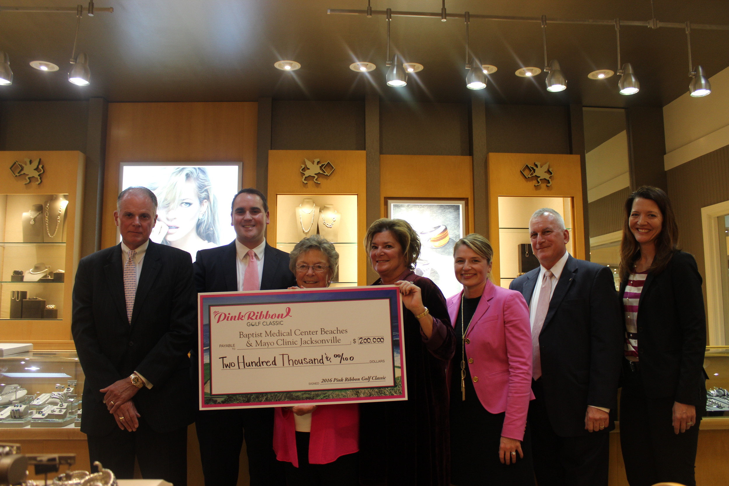 Clayton Bromberg, Jarret Dreicer, Susie Buckey, Christy Bromberg, Dr. Sarah McLaughlin, John Rutkowski and Sarah Smith represent Underwood’s Jewelers, Baptist Medical Center Beaches, the Pink Ribbon Golf Classic and Mayo Clinic-Jacksonville during the check presentation at the John Hardy Trunk Show Nov. 17.