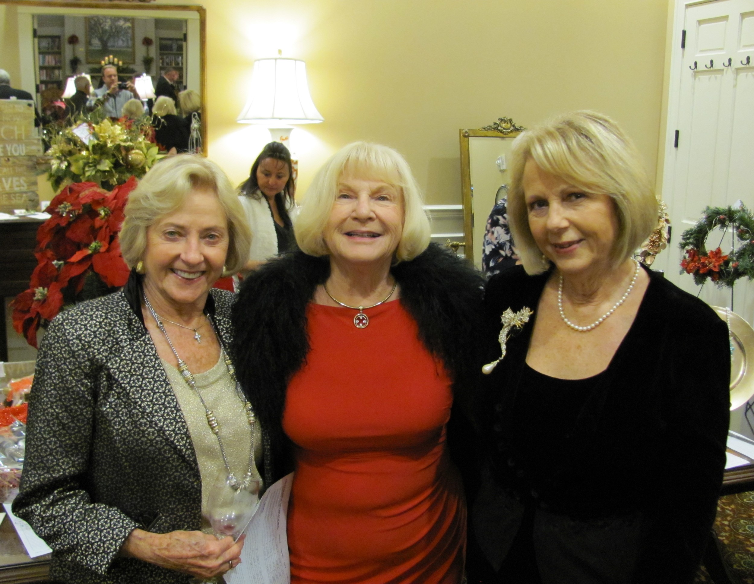 Barbara Cone, Shirley Keyser and Anne Wolfe from the Camellia Garden Club admire the silent auction items at Christmas on the River Nov. 20.
