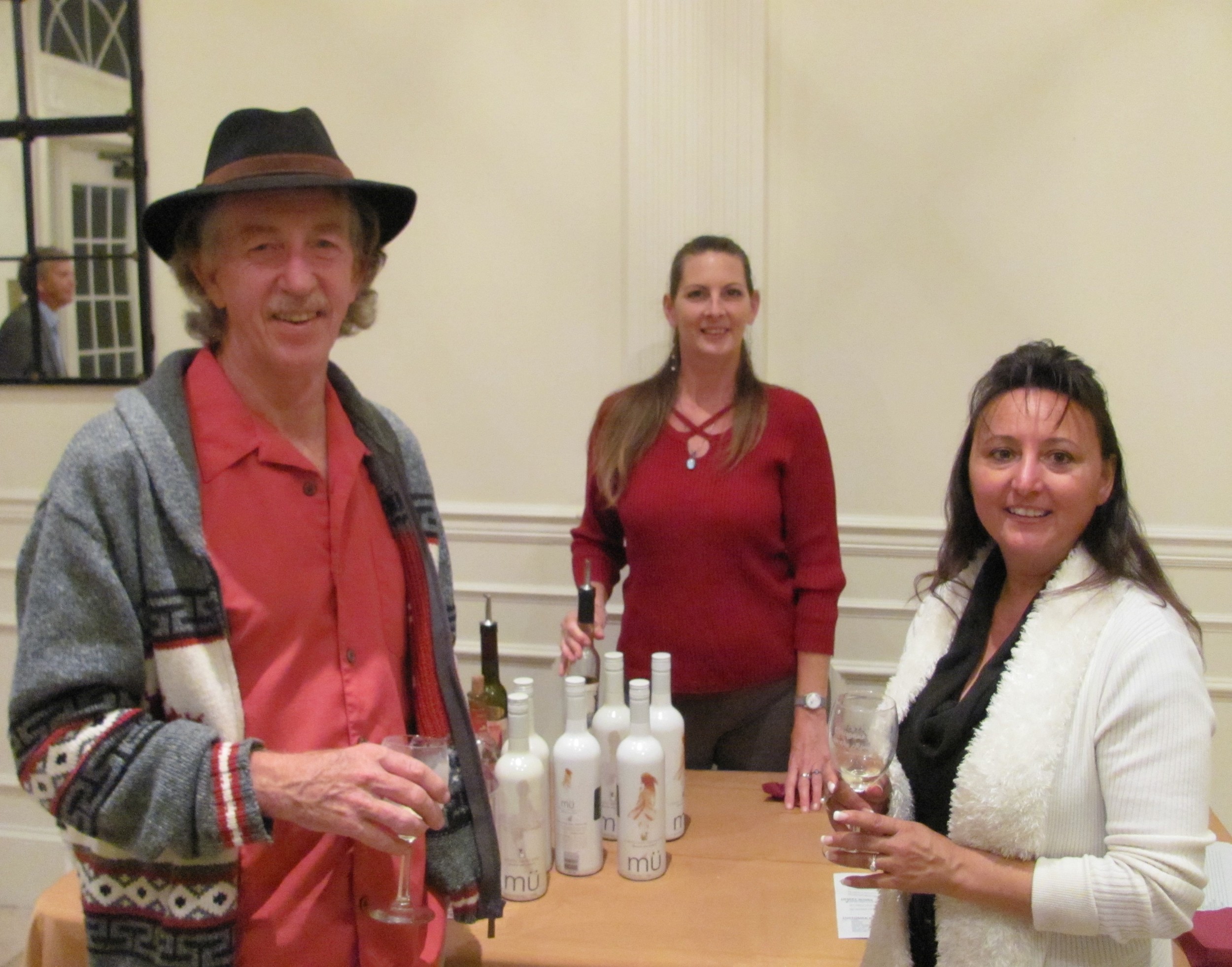 Daryl (left) and Susan (right) Perritt sample wine from Vino Del Grotto Winery thanks to the help of Deb Broyer (center).