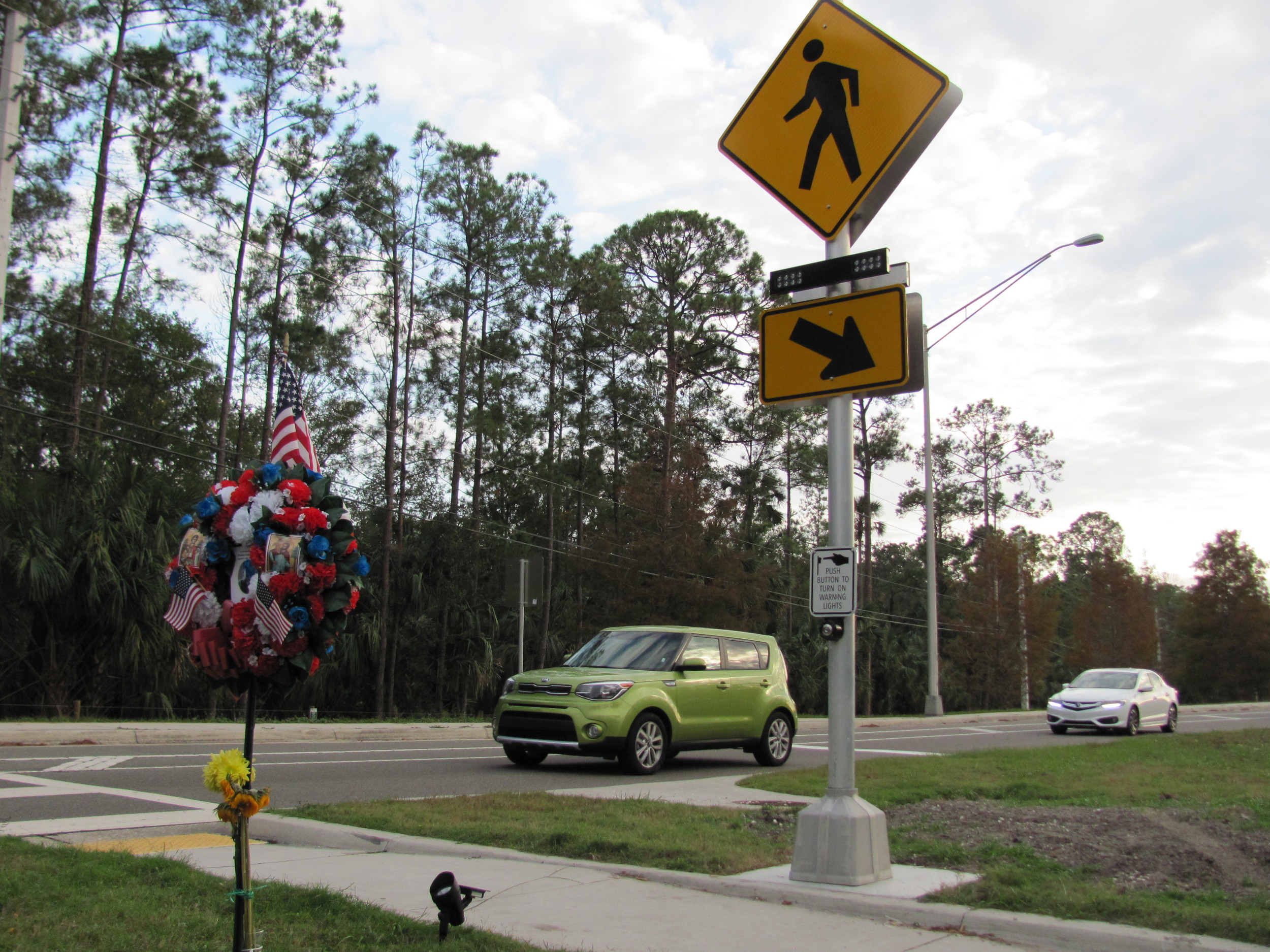 When pedestrians now cross the street at the foot of the Palm Valley Bridge, they can alert motorists by pressing a button that activates flashing signals on the crosswalk signs.