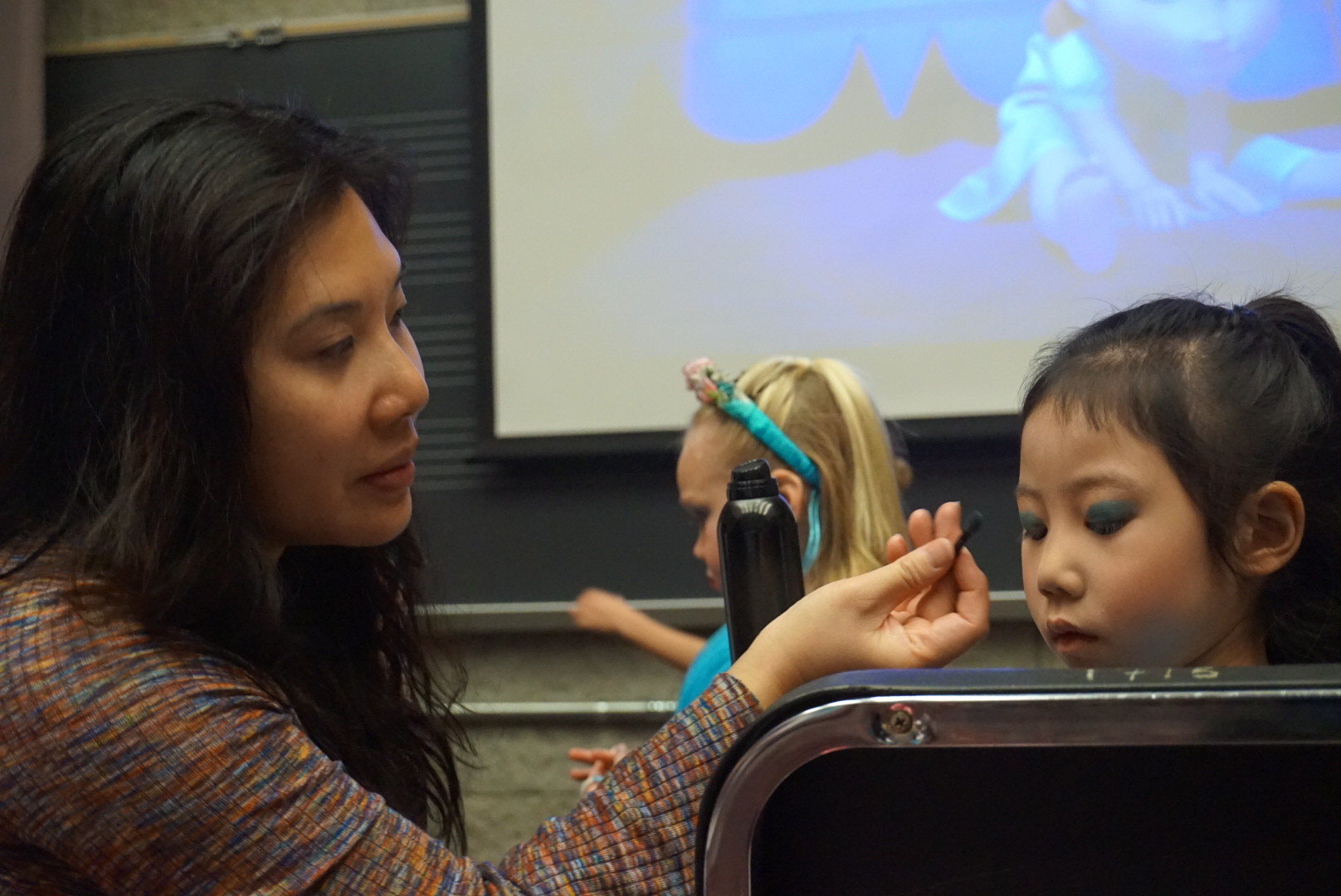 Donna Lee puts the finishing touches on daughter Sophia Lee’s dream fairy makeup.