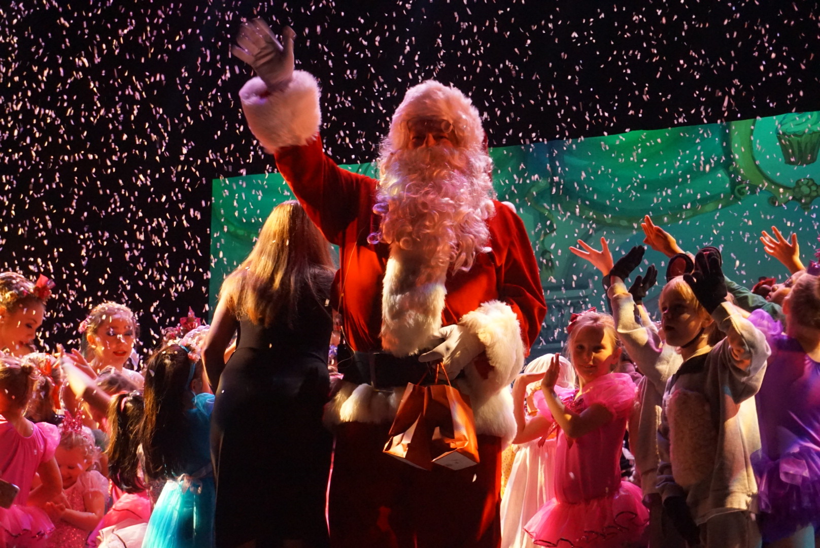 Santa Claus pays a surprise visit to the audience and performers just before curtain call