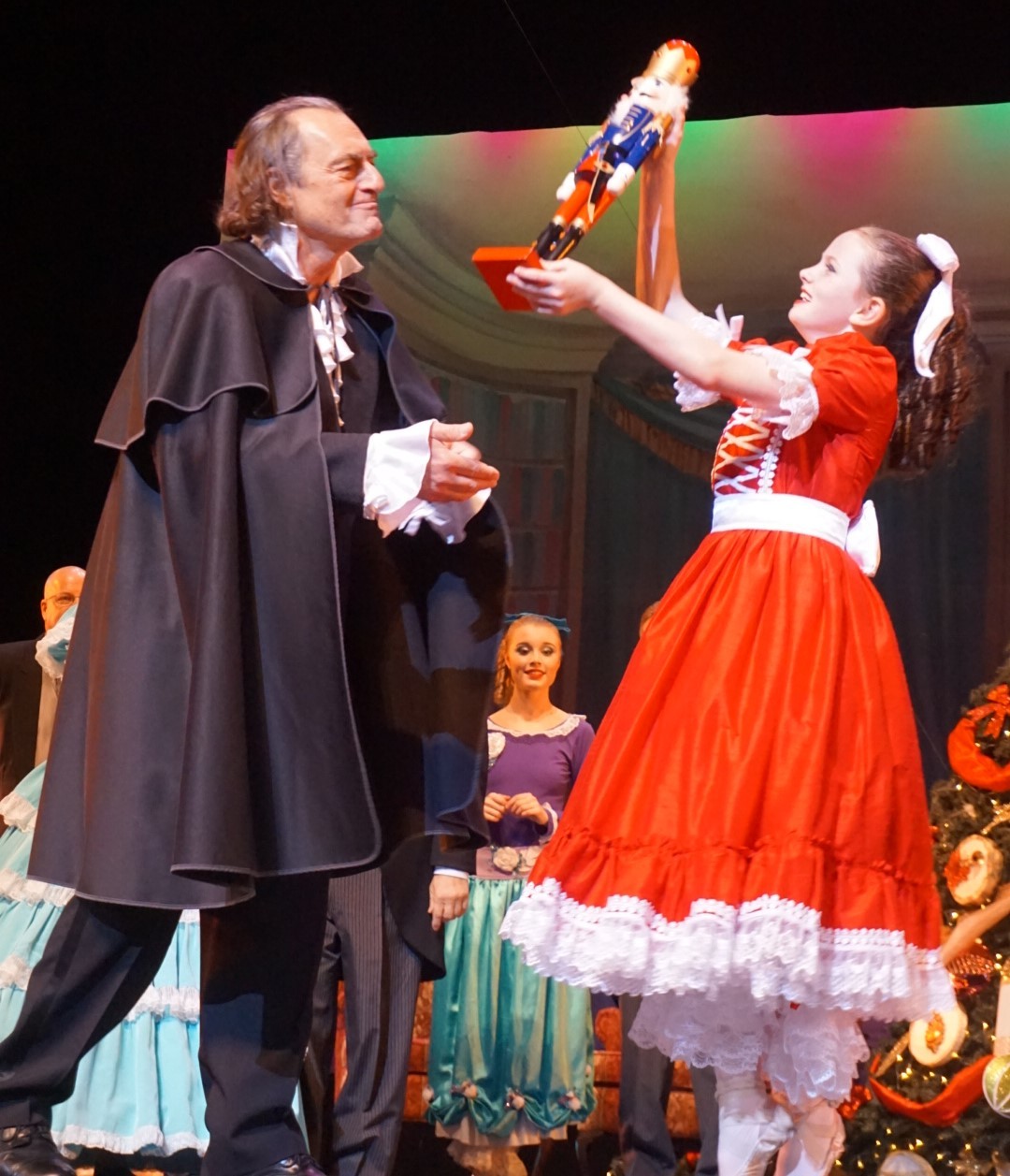 Clara (Marissa Jacobs) admires the Nutcracker given to her by Drosselmeyer (Anthony Egeln, Sr.)