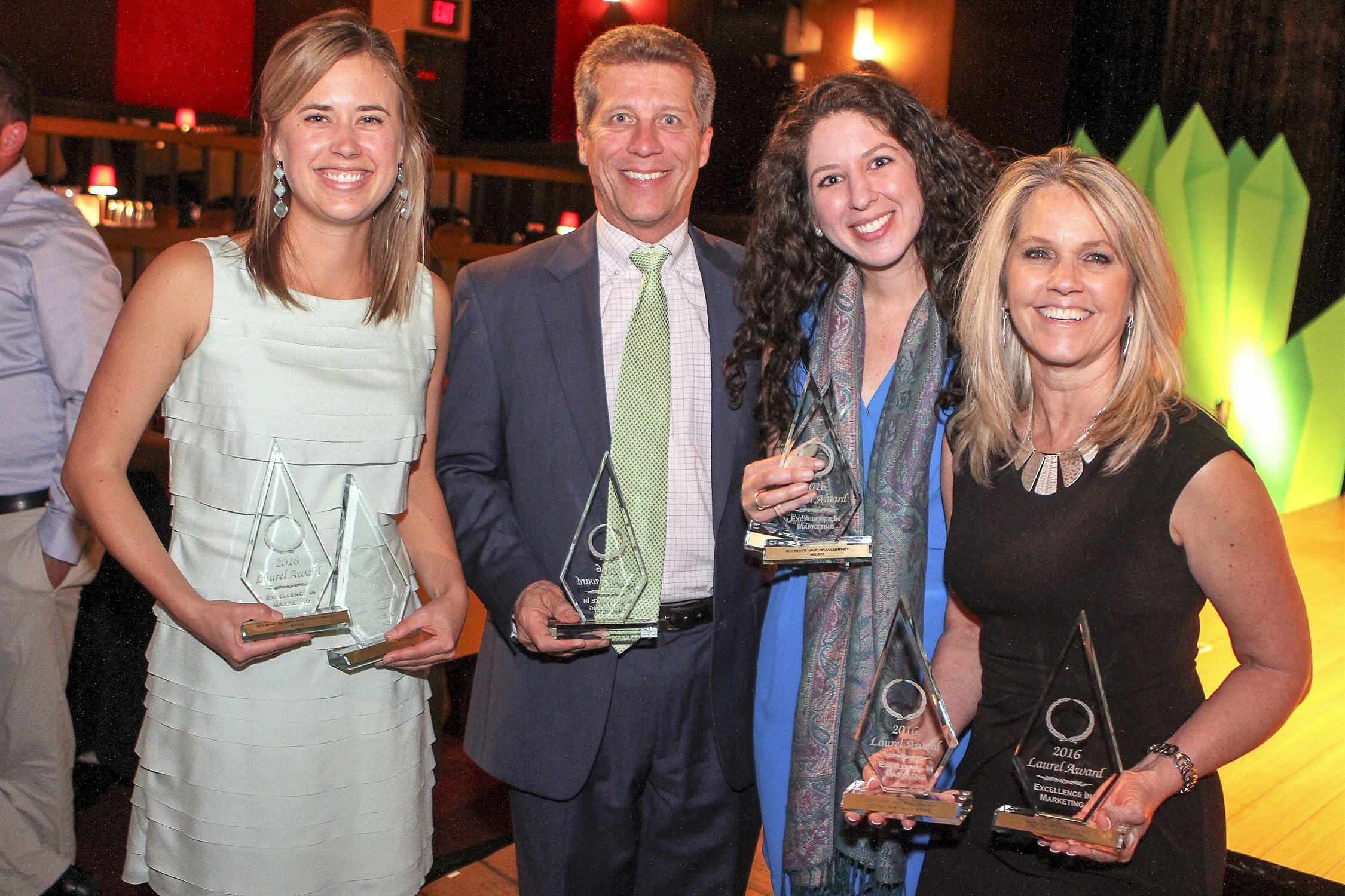 The PARC Group President Rick Ray and the firm’s marketing team display some of the awards Nocatee’s master developer received at the recent Laurel Awards.
