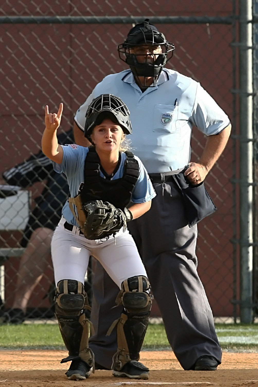 Shark catcher Taylor Bradshaw signals to her teammates that there are two outs in the inning.