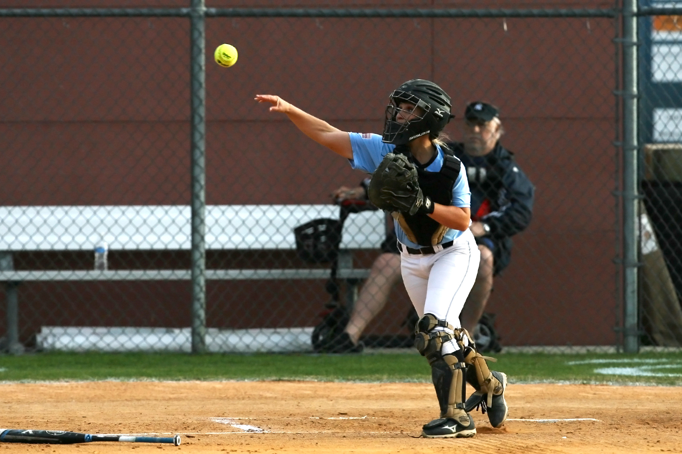 Catcher Taylor Bradshaw throws to first to get the Pedro batter attempting a bunt.