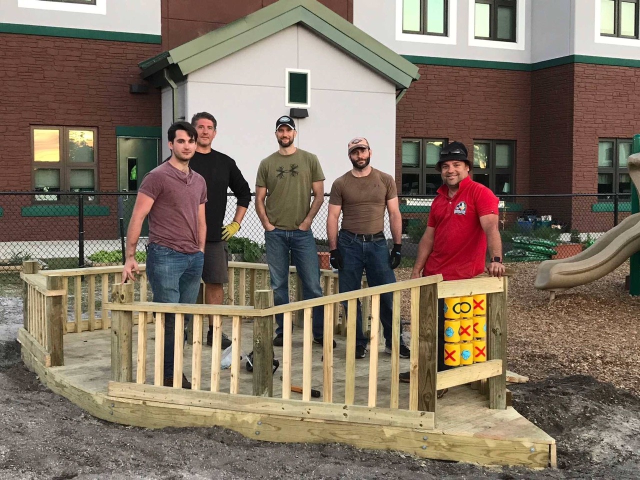 Andy Macy, Christopher Zobel, Alex Kiss, and Cameron Slayden volunteer in a group led by Hector Rodriguez (far right) of Florida Home Remodeling Group, LLC. 