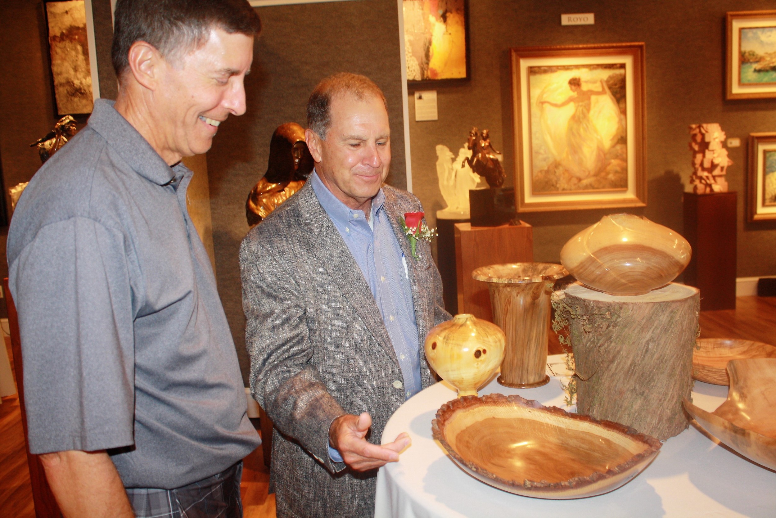 Mark Wood (right) explains his wood turning process to friend Jim Van Horn