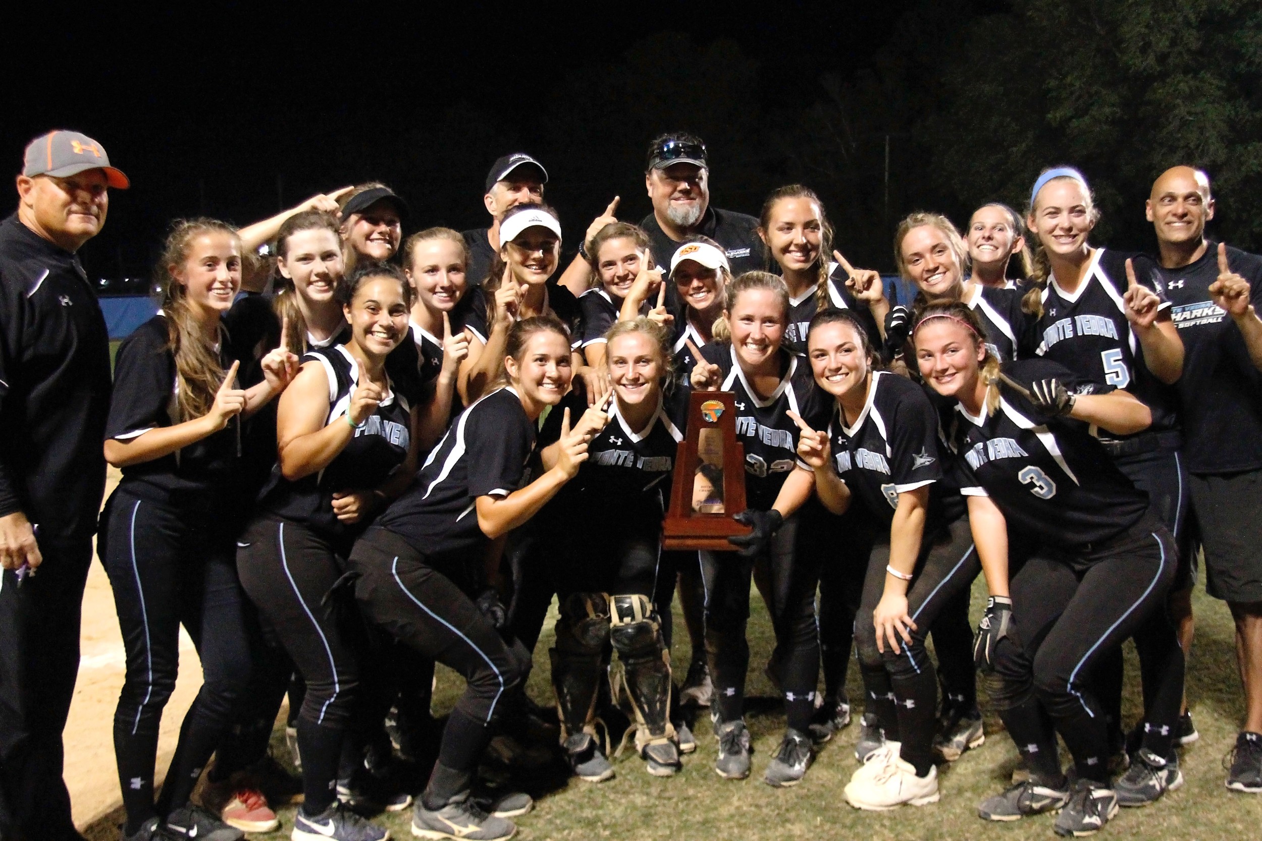 The victorious Sharks celebrate after winning the Class 6A District 4 title.
