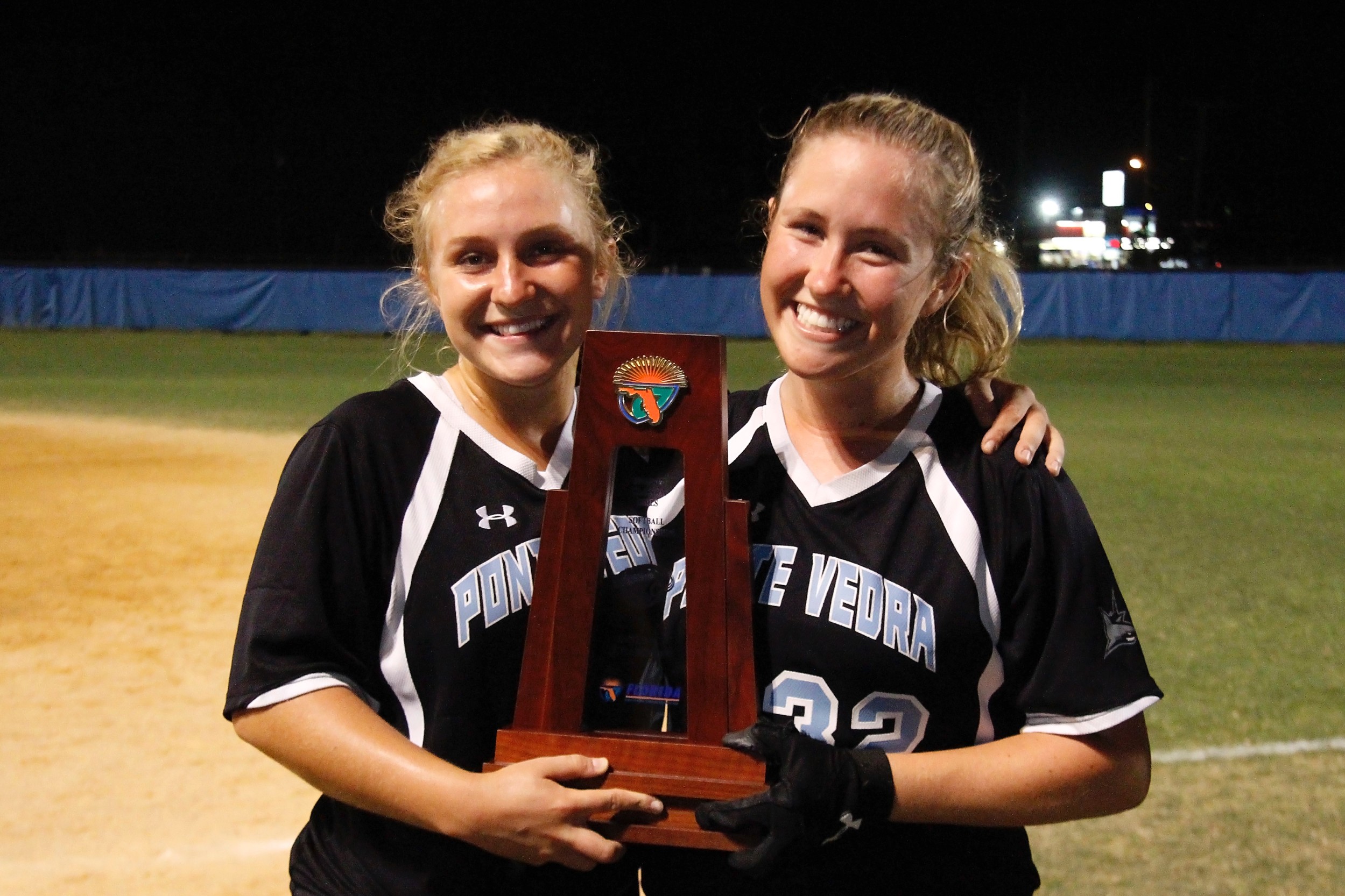 Seniors Taylor Bradshaw (L) and Farley Callaghan pose proudly their district trophy.