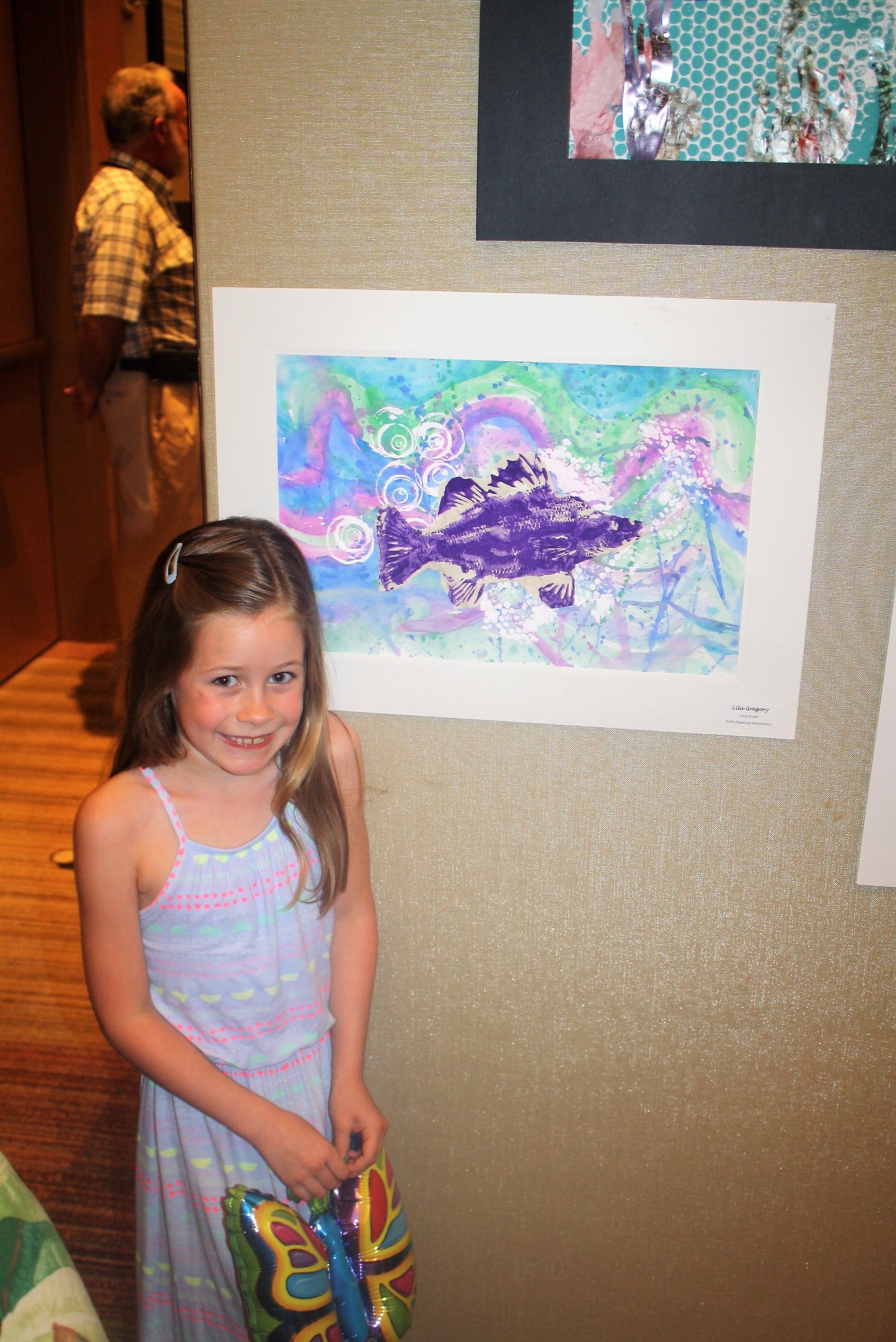 Lila Gregory, 7, displays her artwork
