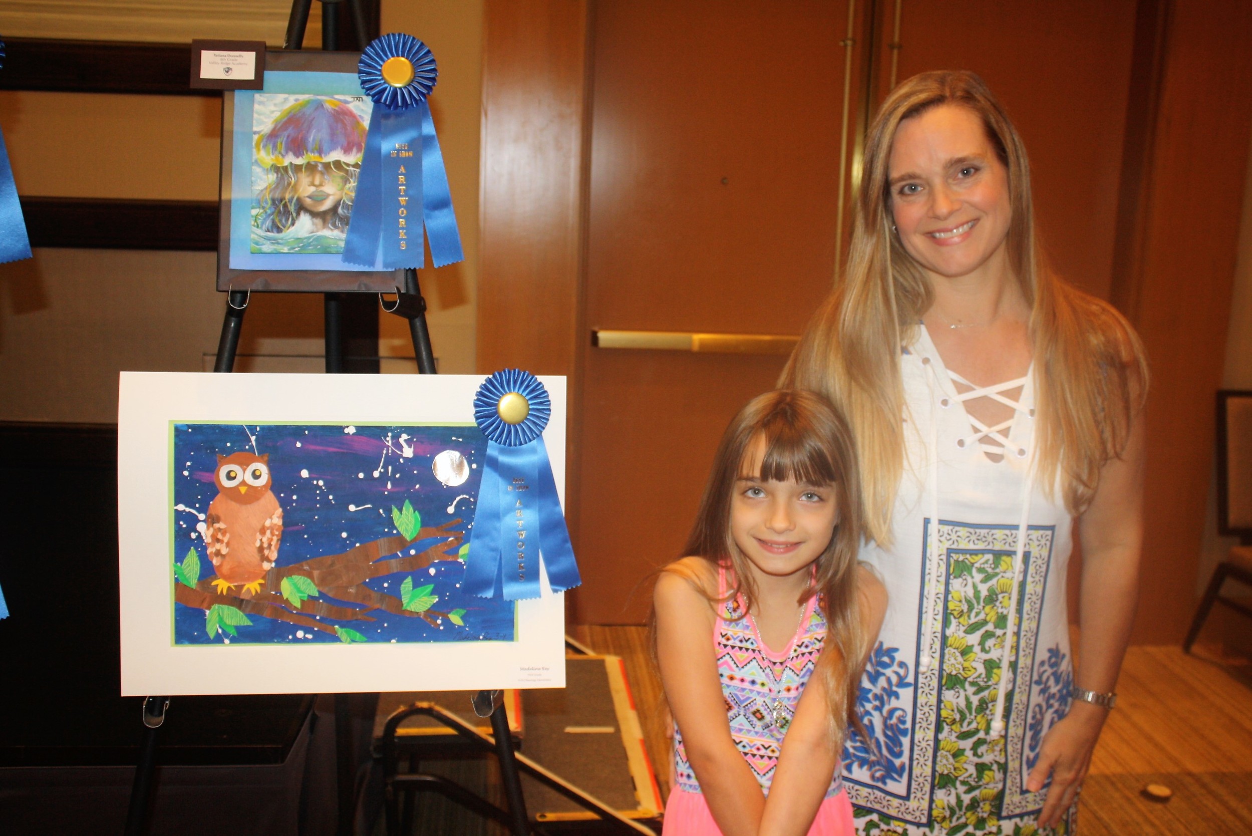 Madeline Rey and her mother, Deborah, stand next to Madeline's prize winning artwork (bottom)